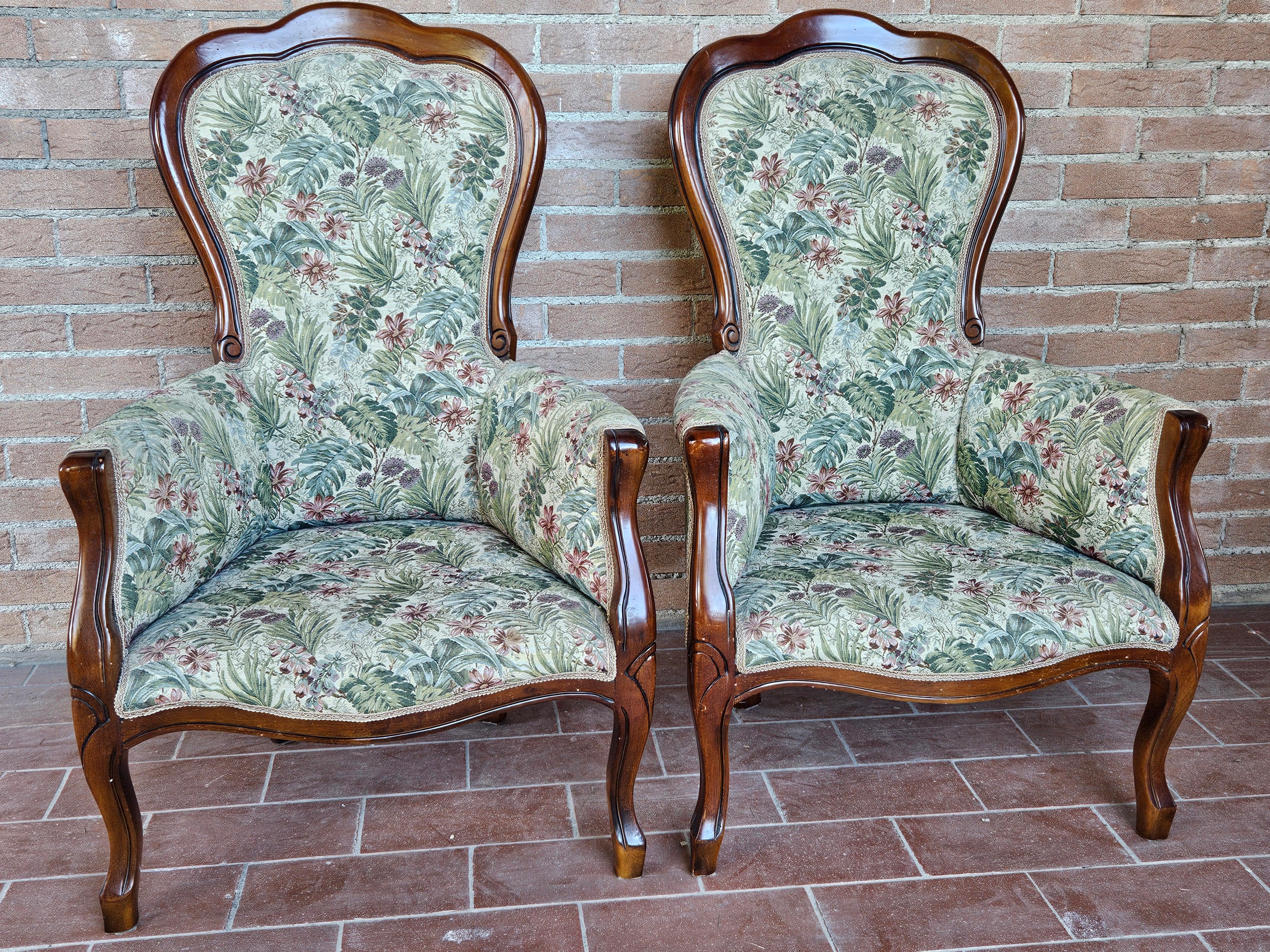 Pair of Louis Philippe-style upholstered armchairs with walnut frame and floral fabric.

Normal signs of wear due to age and use.
