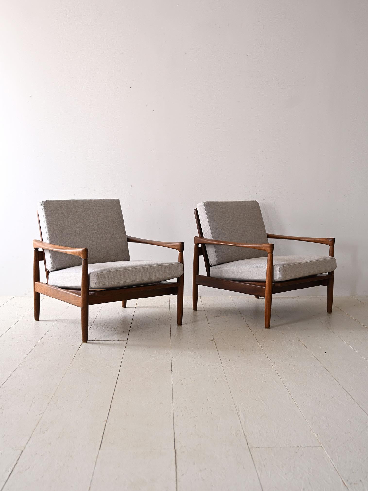 Set of two original 1960s armchairs designed by Erik Wörtz for Ikea.
Made with a high-quality teak frame, these armchairs feature a slightly sloping backrest that promises an optimal relaxation experience, while the two upholstered cushions covered