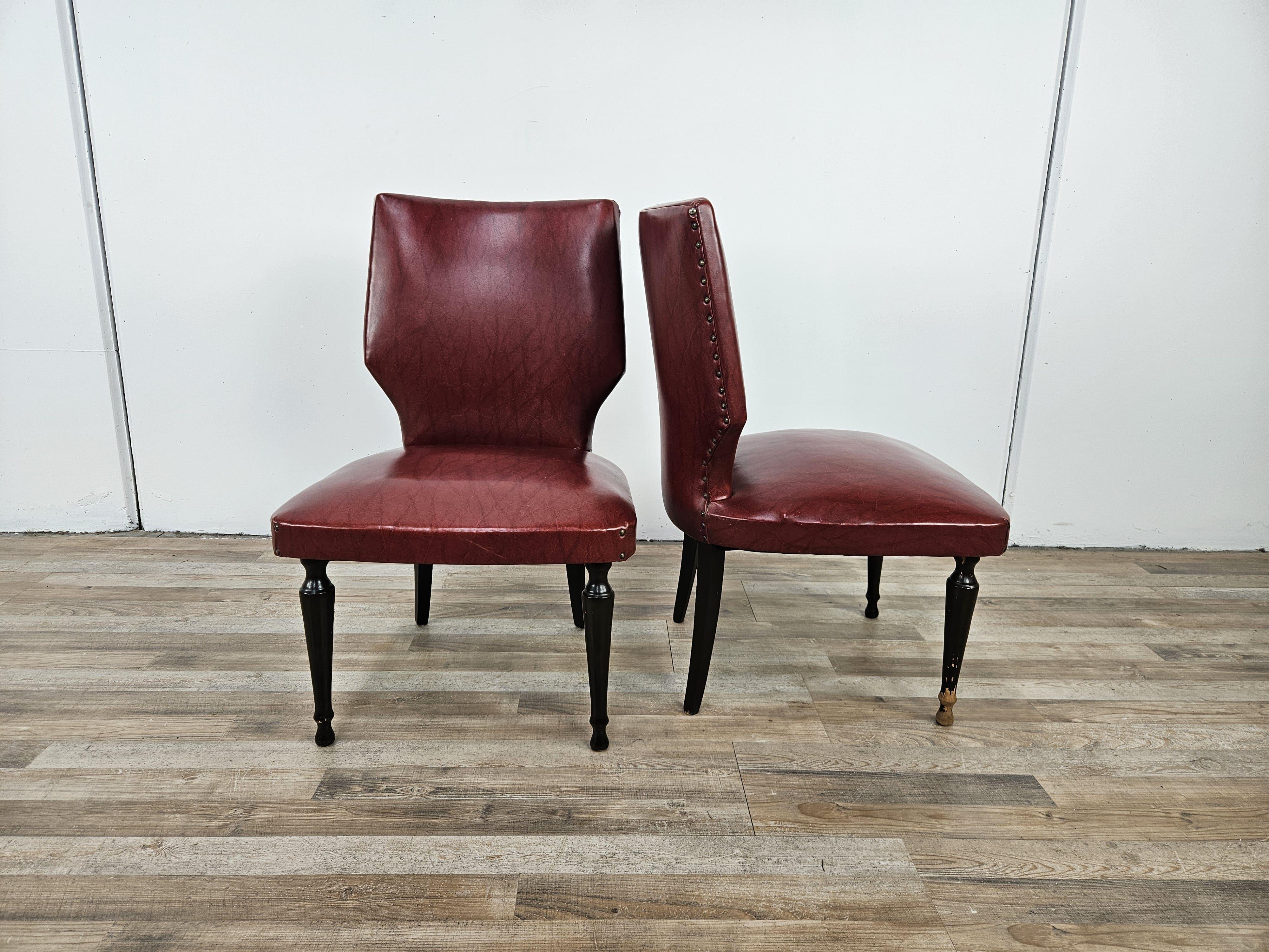 Coppia di sedie vintage anni '60 italiane con struttura in legno e imbottitura in skai bordeaux arricchita da borchie lungo il retro schienale.

Normali segni d'usura come da foto.