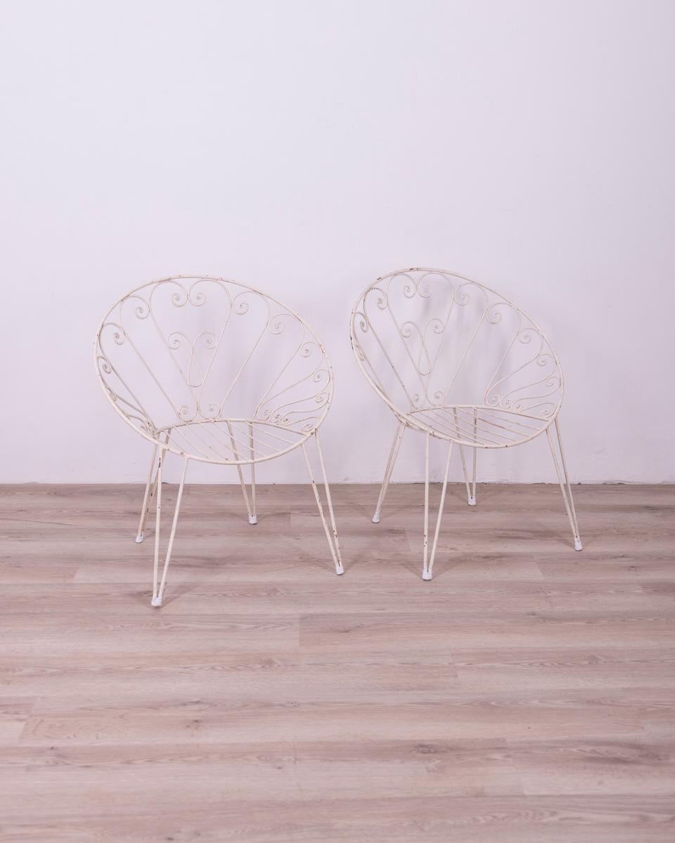Pair of white painted metal garden chairs, Italian design, 1960s.

CONDITION: In good condition, show signs of wear given by time.

DIMENSIONS: Height 78 cm; Width 68 cm; Length 55 cm

MATERIALS: Metal

YEAR OF PRODUCTION: Anni 60