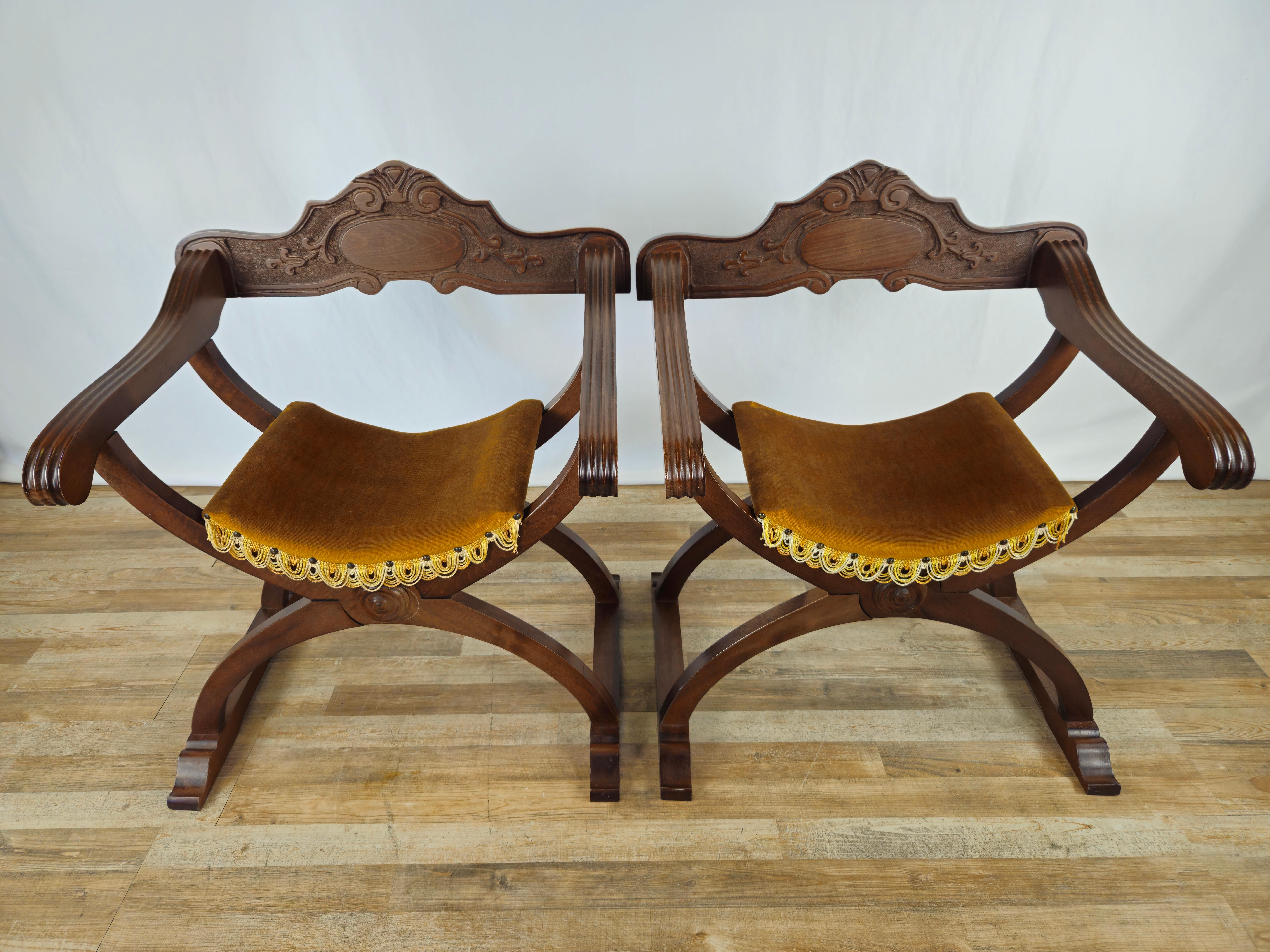 Pair of Savonarola model chairs in walnut wood with upholstered seat in original fabric of the period.

The chairs have a carved backrest attached with two screws at the back for removal and eventual folding for storage.

Normal signs due to age and