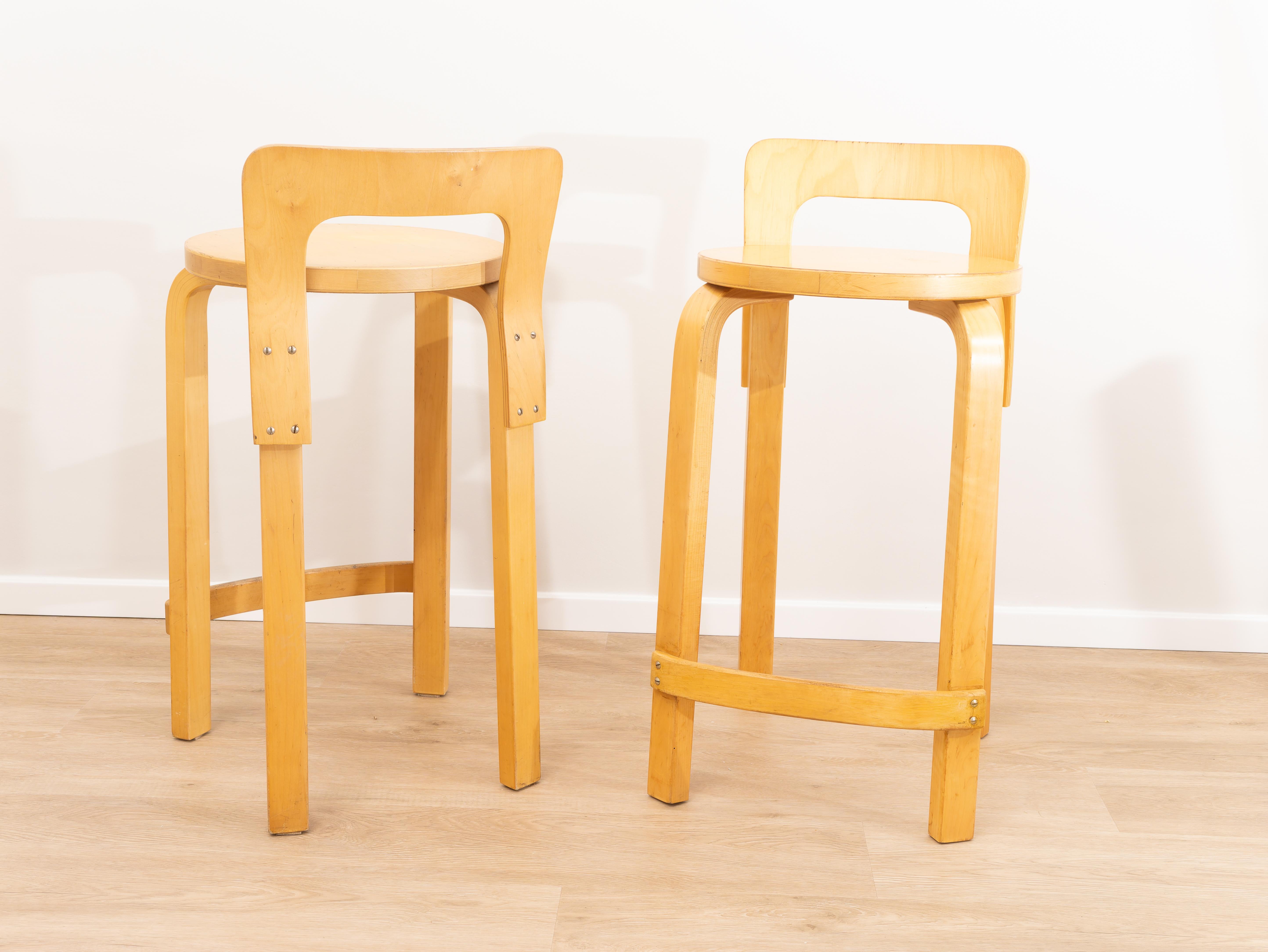 Pair of Stools model K65 by Alvar Aalto for Artek, Finland, 1950s. 
The K65 stool was prayed for by Alvar Aalto in the 1930s. The height is designed to be adapted with tall tables or islands. The low back gives the right support to the person, and