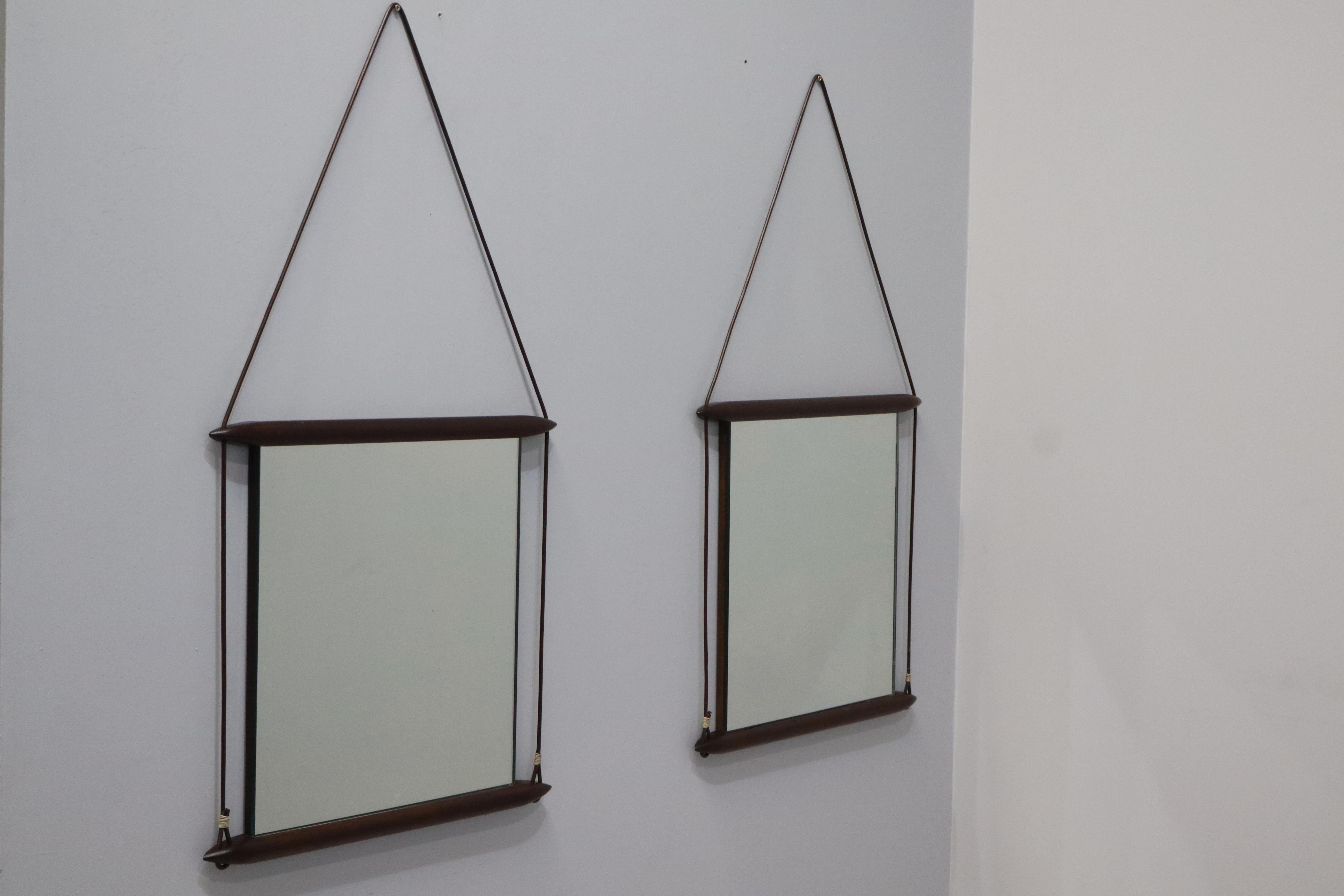 Wall mirrors designed by Ico Parisi in the late 1950s and produced by Mobili Italiani Moderni (MIM). 
The frame of the mirror is in wood and Leather Ribbon. 
The back of the mirror is also made of wood and has the MIM mark and serial number , as