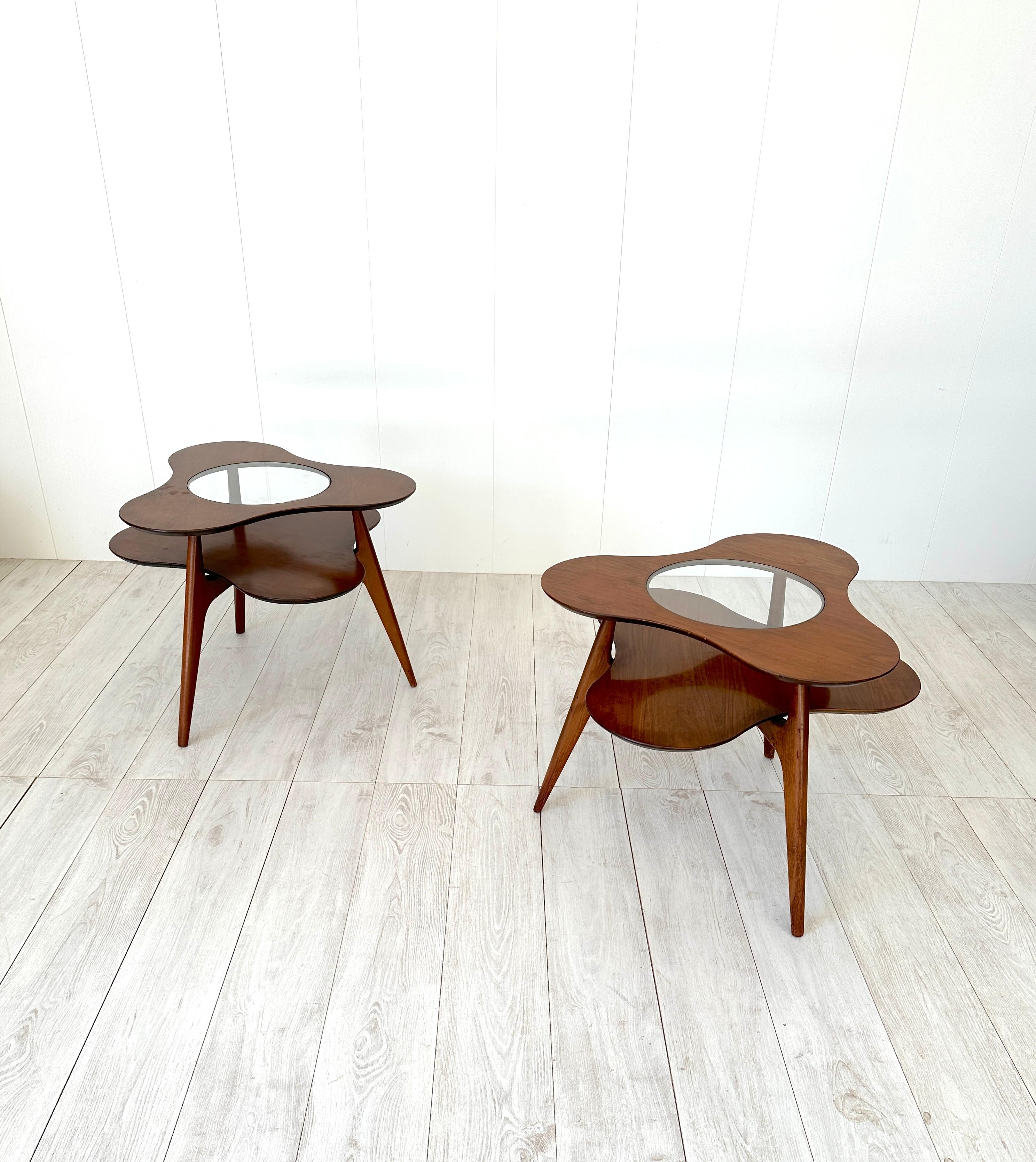 Peculiar pair of flower-shaped side tables made of wood with glass center part.
Production dates back to the 1950s. They make the environment elegant with a modern touch.
