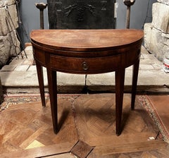 A pair of half-moon-shaped card tables in walnut and mahogany, Louis XVI style.