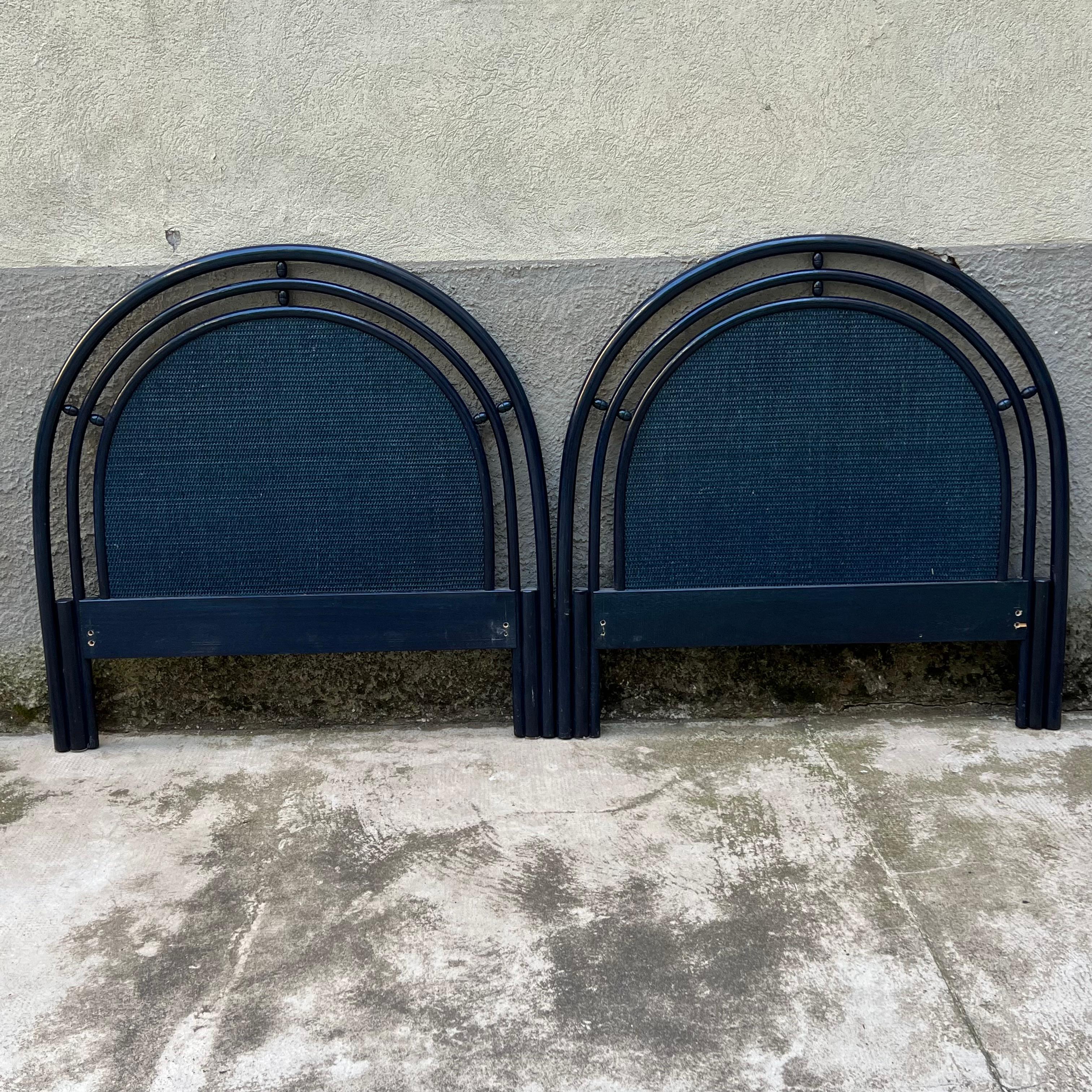 Pair of elegant headboards for single beds, made of wood and rattan with a refined deep blue finish. These headboards, produced in the 1980s by the Italian company Roberti Rattan, are a perfect blend of classic design and quality craftsmanship.