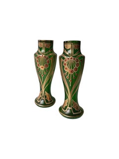 A pair of Art Nouveau vases made of green glass with cabochon stones set into them.