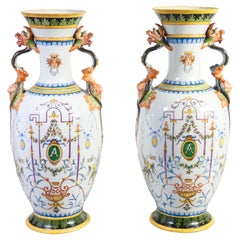Pair of painted ceramic vases with grotesques, carvings on handles. 1887