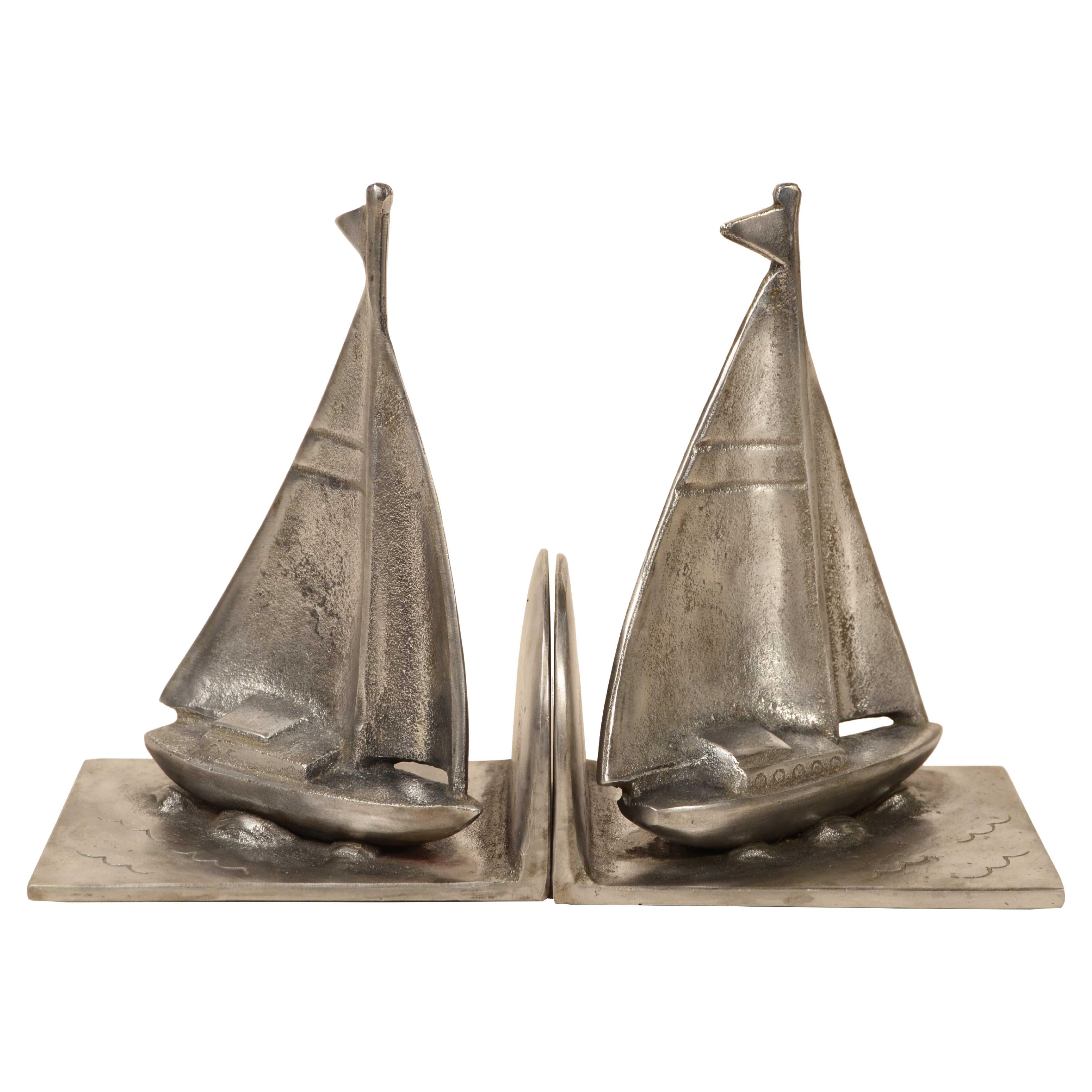 Pair of steel bookends depicting sailboat sailing circa 1930s