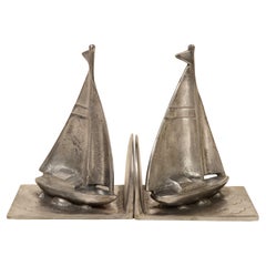 Pair of steel bookends depicting sailboat sailing circa 1930s