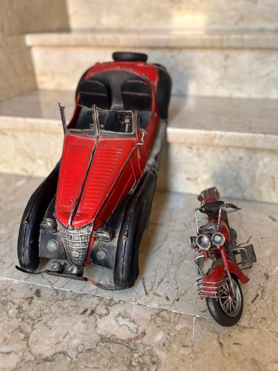 Pair of decorative and collectors' toys.
Metal and tin processing  handmade 1970.
Vintage unique decorations. For true amateurs.
Car dimensions: Height :  17   Width : 20 cm      Depth : 55 cm 
Motorcycle dimensions:  Height :  15  Width : 10   
