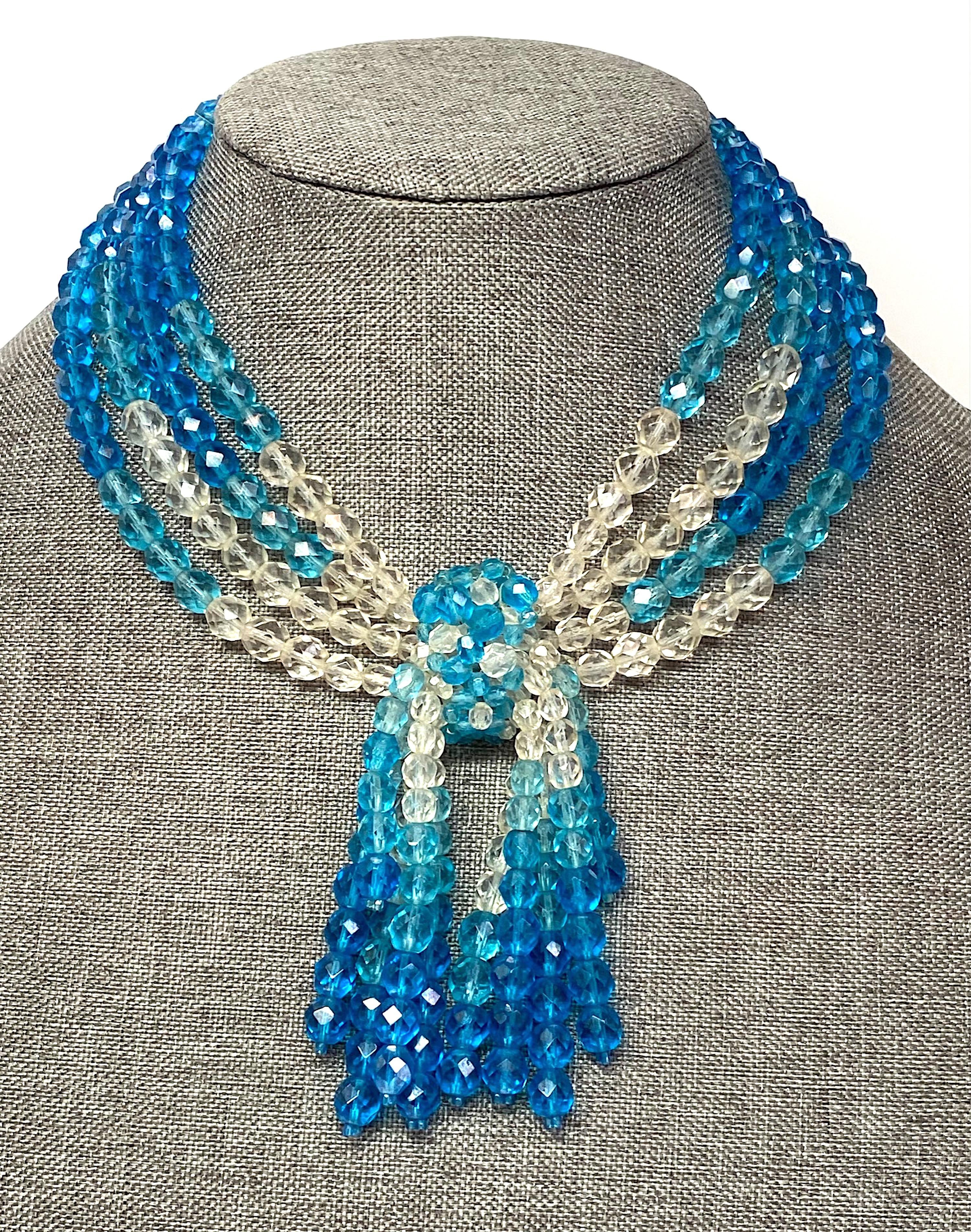 A lovely 1950s necklace by the famous Italian jewelry designers Bruno and Lyda Coppola. The necklace is comprised of hand strung clear, light and royal blue faceted crystal bead. Each side of the necklace has four strands meaning at the triangular