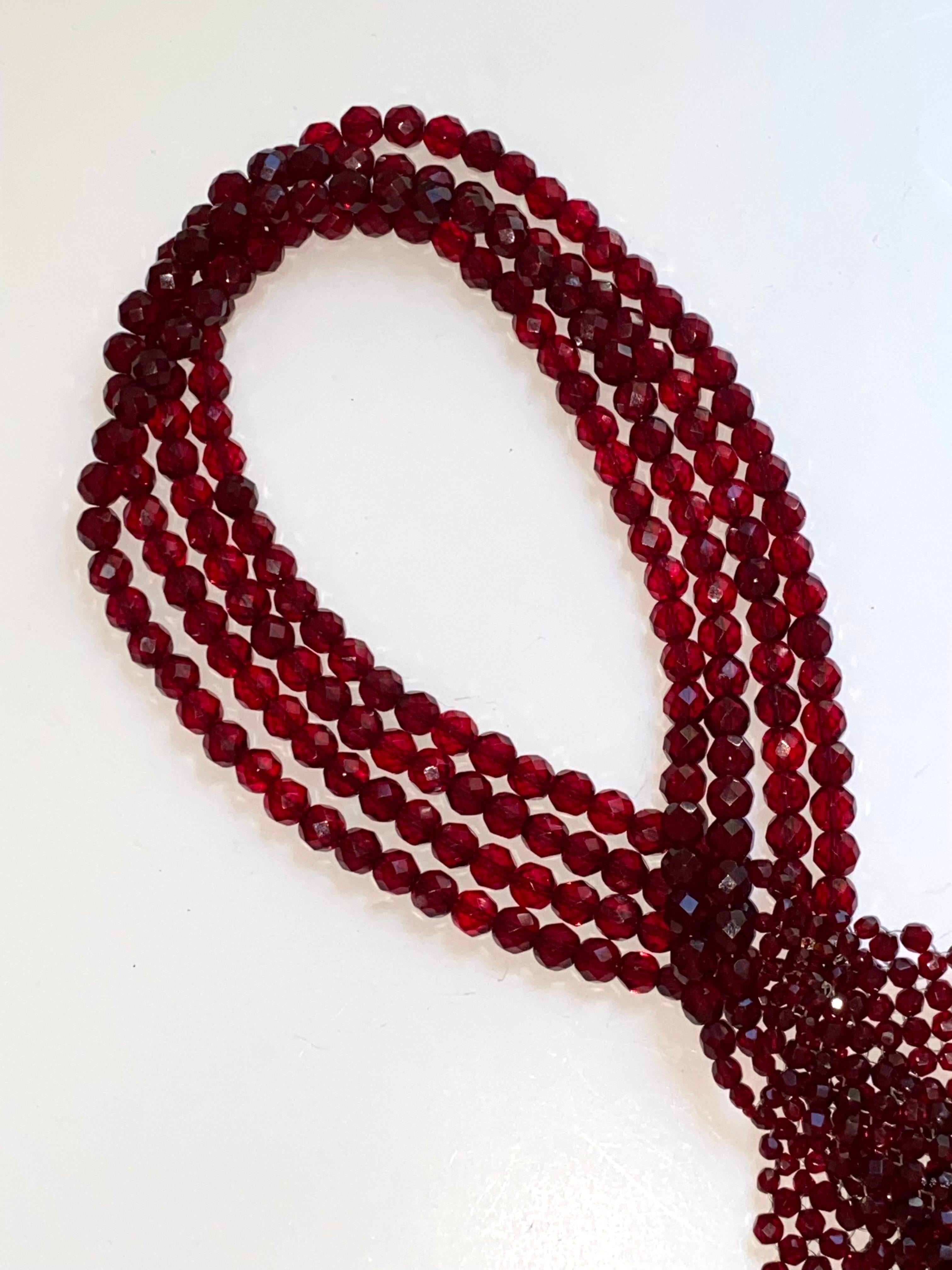 A  lovely and unique design of woven burgundy faceted crystal bead scarf attributed to the Italian jewelry designer brother and sister team Bruno and Lyda Coppola. Unsigned, as there is no use of metal on the necklace. However, it is still the