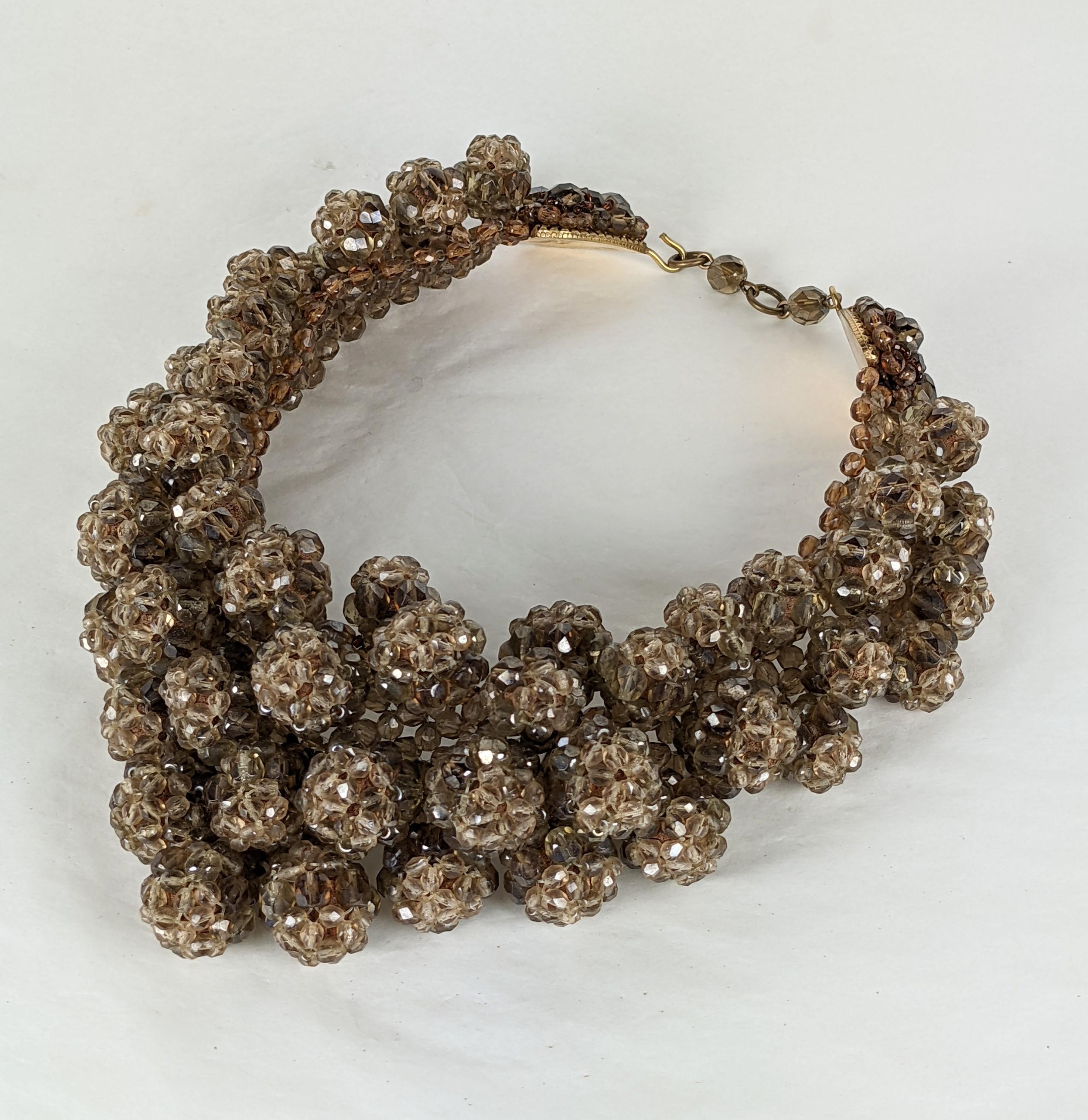 Elaborate and striking Coppola et Toppo Beaded Berry Bib from the 1960's Italy. Intricately beaded berry motifs are attached to a beaded collar of the same beads in smokey faceted resin. Elaborately beaded back plate closure with signature.  1960's