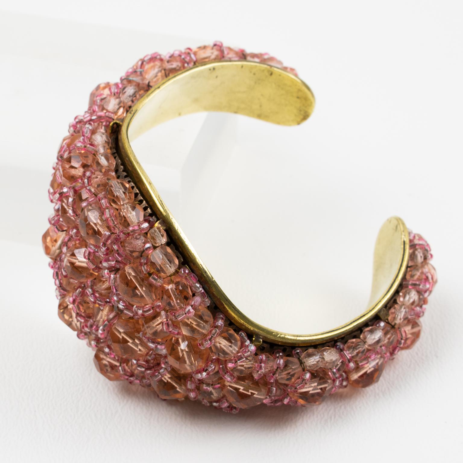 Coppola and Toppo designed this fabulous rare cuff bracelet in the 1950s. The bracelet boasts a brass framing and is ornate with multi-strands of beads brought together to form a striking intricate design. 
As with all of their necklaces and