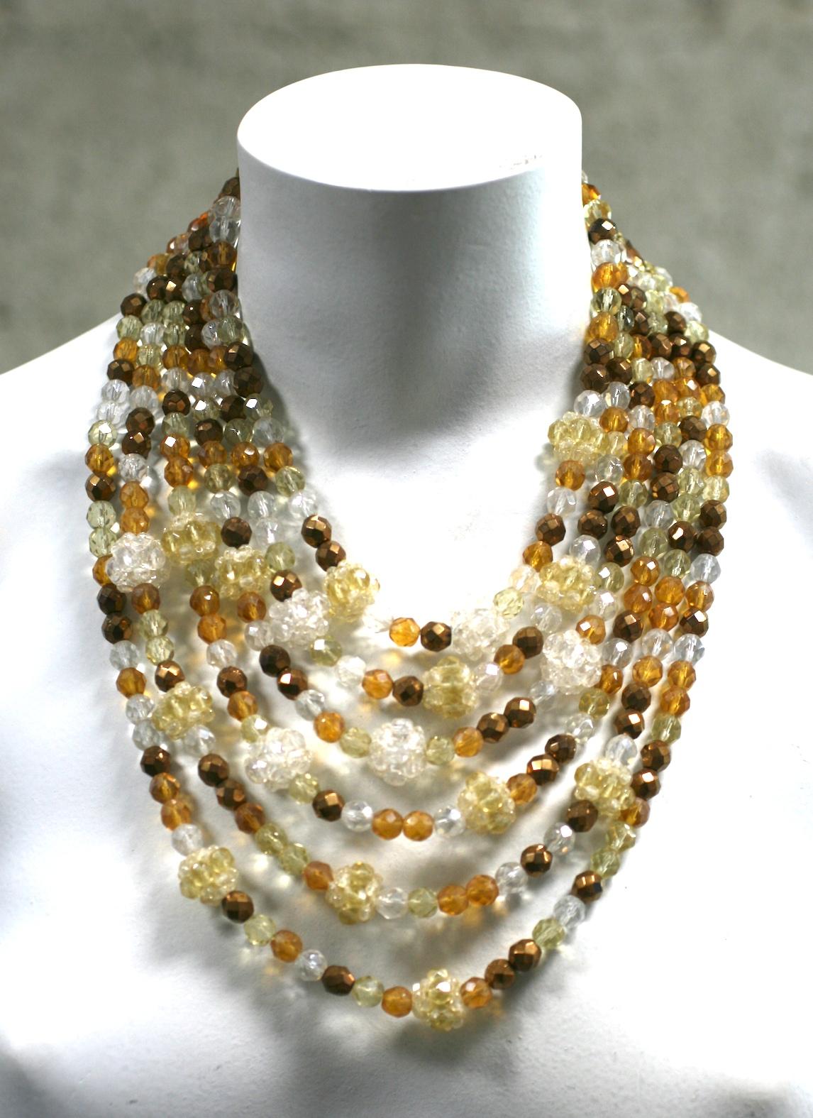 Exceptional Coppola Toppo Beaded Bib in tones of citrine and crystal mixed with copper flashed beads. Throughout the strands are interdispersed larger hand beaded spheres made of the same tonal crystals. Elaborate hand beaded clasp with signature.