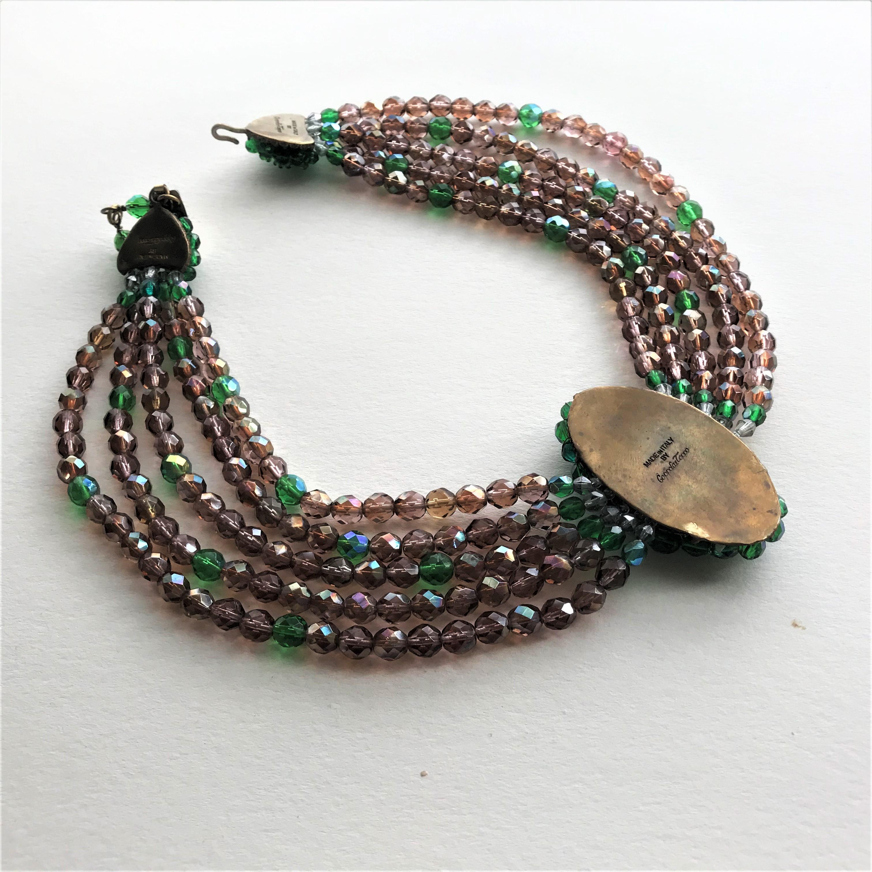 Impressive 5 row crystal necklace in brown and green cut Crystal stones. Elaborate hand beaded clasp with signature and the hand beaded  
green  oval middle part also with the 'MADE OF ITALY BY Coppola & Toppo''. The brown, cut stones are slightly