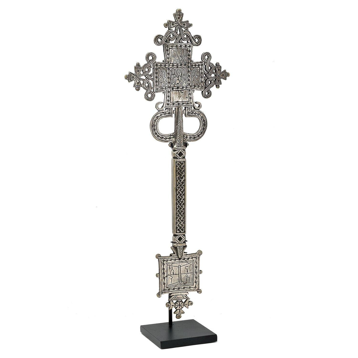 Coptic hand cross, Ethiopia.

Carried by hand during services
Ethiopia
Silver-plated copper alloy
Mid 20th century
Measures: 15.5 x 5.75 x 0.5 in. / 39 x 15 x 1 cm
Height on custom display stand: 16.5 in. / 42 cm.