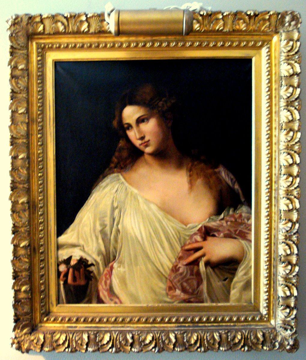 Titian painted Flora, circa 1515. We believe this is an early 16th century copy by Jacopo Palma il Vecchio (1480-1528) in a magnificent antique gold leaf frame. The original (shown in the last image) hangs in the Uffizi Gallery in Florence.

The