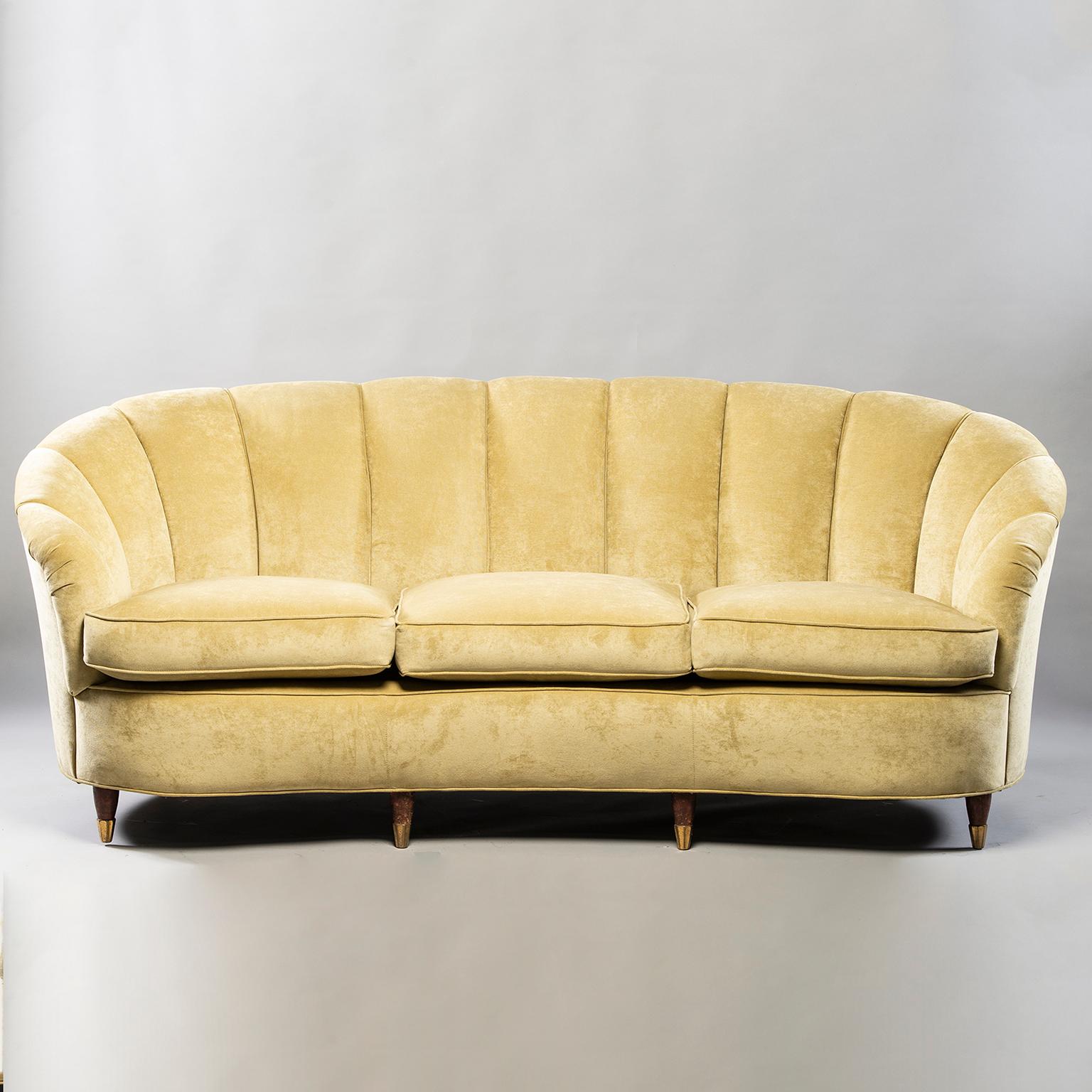 Sofa and chairs trio found in Italy and attributed to Paolo Buffa, circa 1940s. Coquille (shell) form channel back sofa and chairs have curved backrests and slightly flared arms and tapered wood legs with brass caps. Newly upholstered in a pale sage