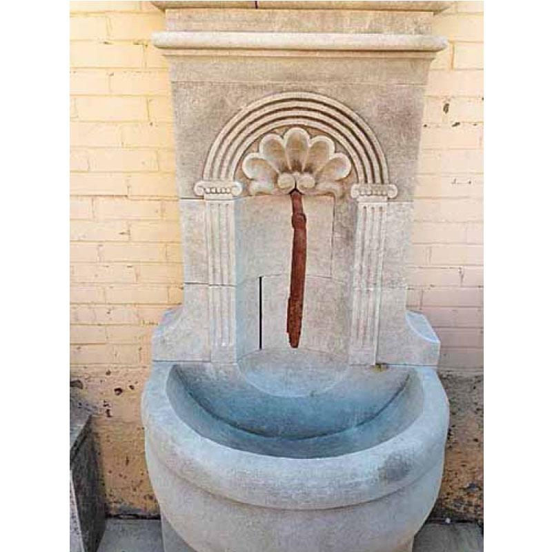 Here we have a hand carved limestone wall fountain from France with a shell design and semi-circular basin on a stand. Similar to out 