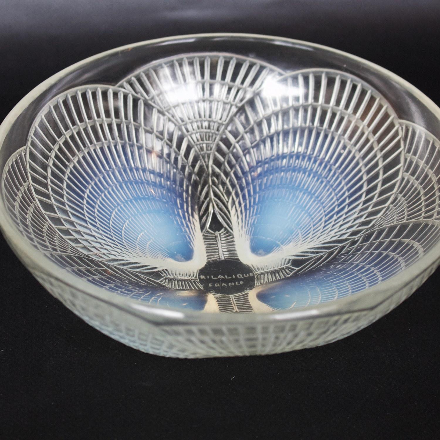 Coupe coquilles no. 3, an Art Deco, blue opalescent glass bowl. Covered over with raised, geometric motif of scallop shells.

Model no. 3200 – Etched R Lalique France and numbered to base.

Literature: Marcilhac, R Lalique Catalogue Raisonné de