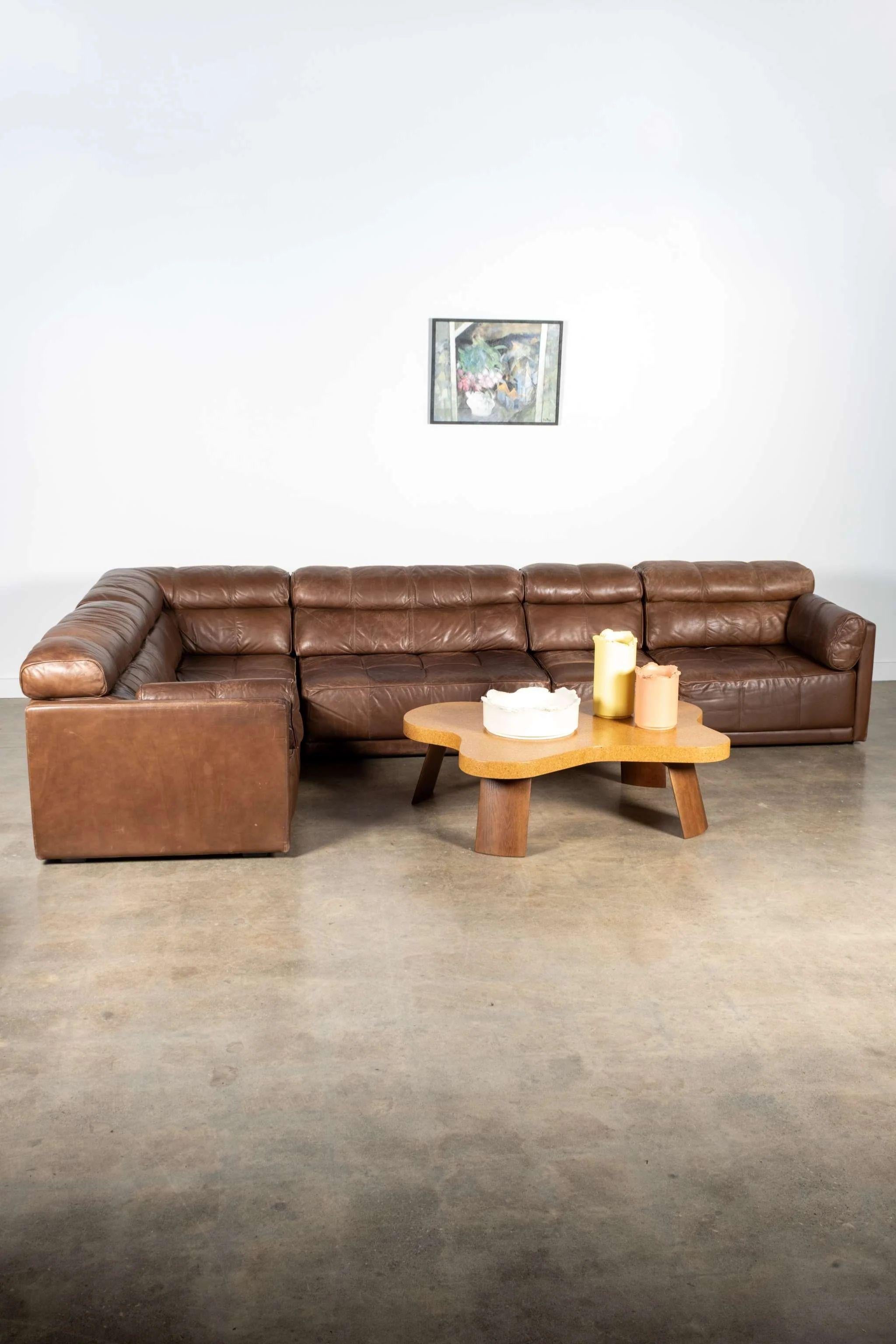 Crafted by German manufacturer COR in the 1970s, this modular leather sofa embodies the era’s blend of comfort and geometric precision. Its low-slung profile and deep, tufted cushions invite an easy kind of lounging, while the supple patinated
