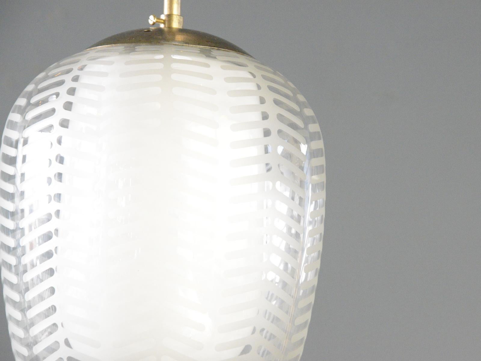 Cora Pendant Lights By Wilhelm Wagenfweld For Peill & Putzler

- Opaline glass central diffuser 
- Fern patterned clear outer glass
- Takes E27 fitting bulbs
- Brass tops
- Designed by Wilhelm Wagenfeld
- Produced by Peill & Putzler, Duren
- Model