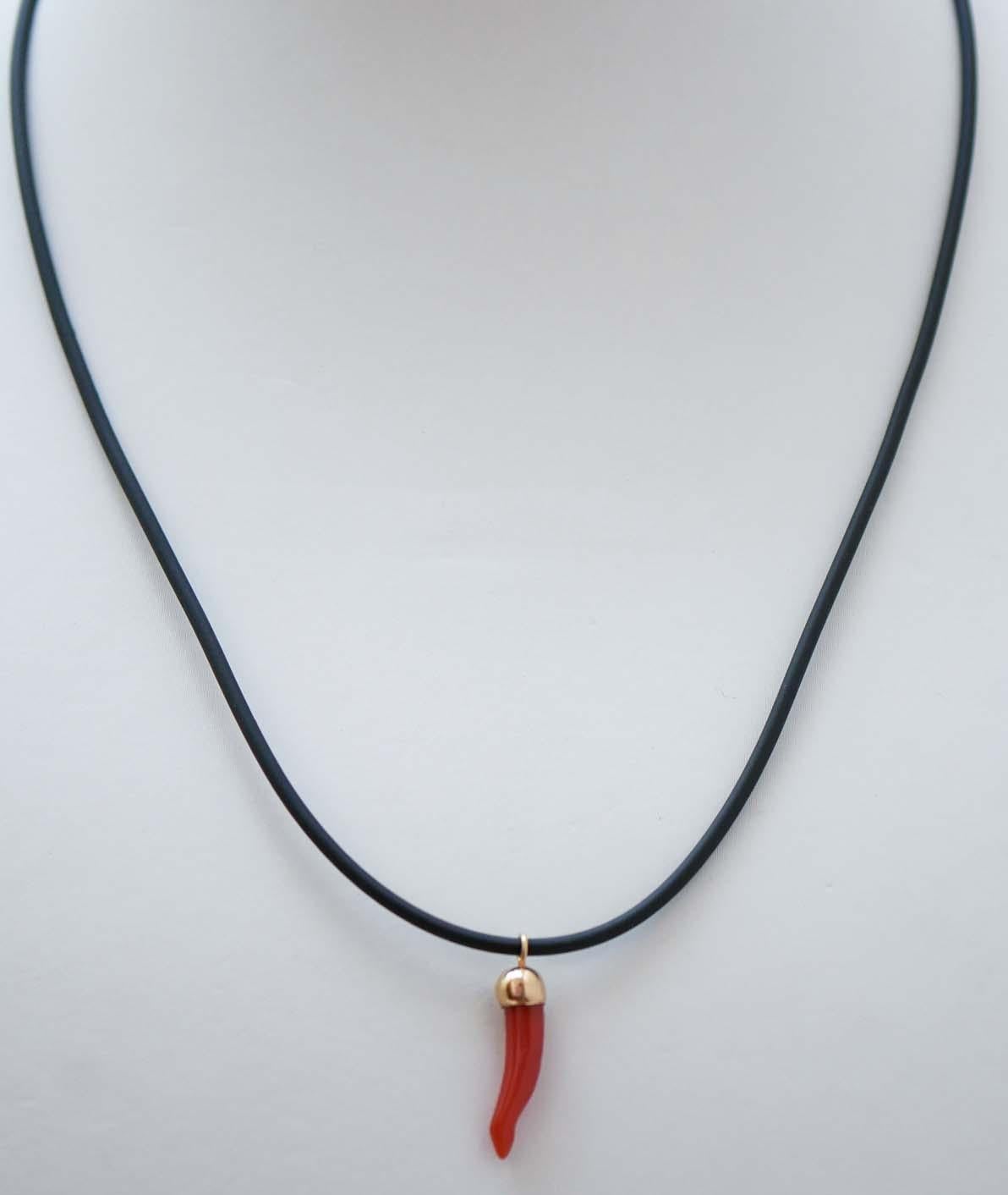 Fashion pendant in 18 kt yellow gold mounted with horn lucky charm of coral. The horn lucky charm is a typical symbol of the ancient Neapolitan culture.
The rubber chain with steel closure is included.
This pendant was totally handmade by Italian