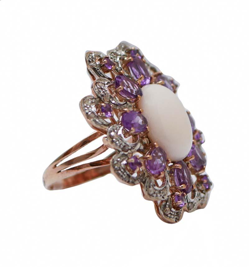 Amazing retrò ring in 9 kt rose gold and silver structure mounted with a central pink coral surrounded by a frame of amethysts and diamonds.
This ring was totally handmade by Italian master goldsmiths and it is in perfect conditions.
Diamonds 0.76