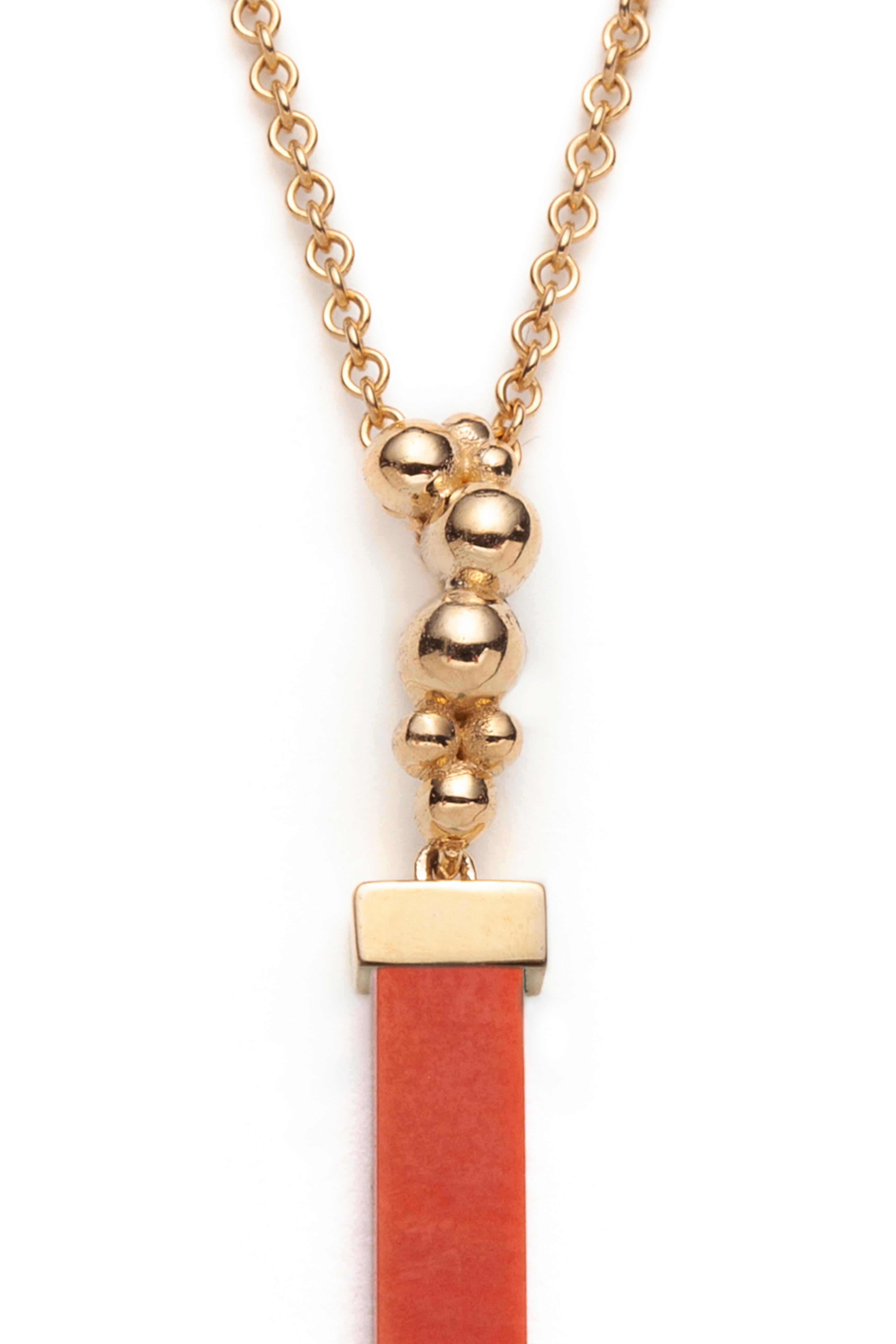 We make this colorful pendant in 14k yellow gold set with a rectangular Coral batons and a citrine teardrop. The pendant length is 42mm. The 18