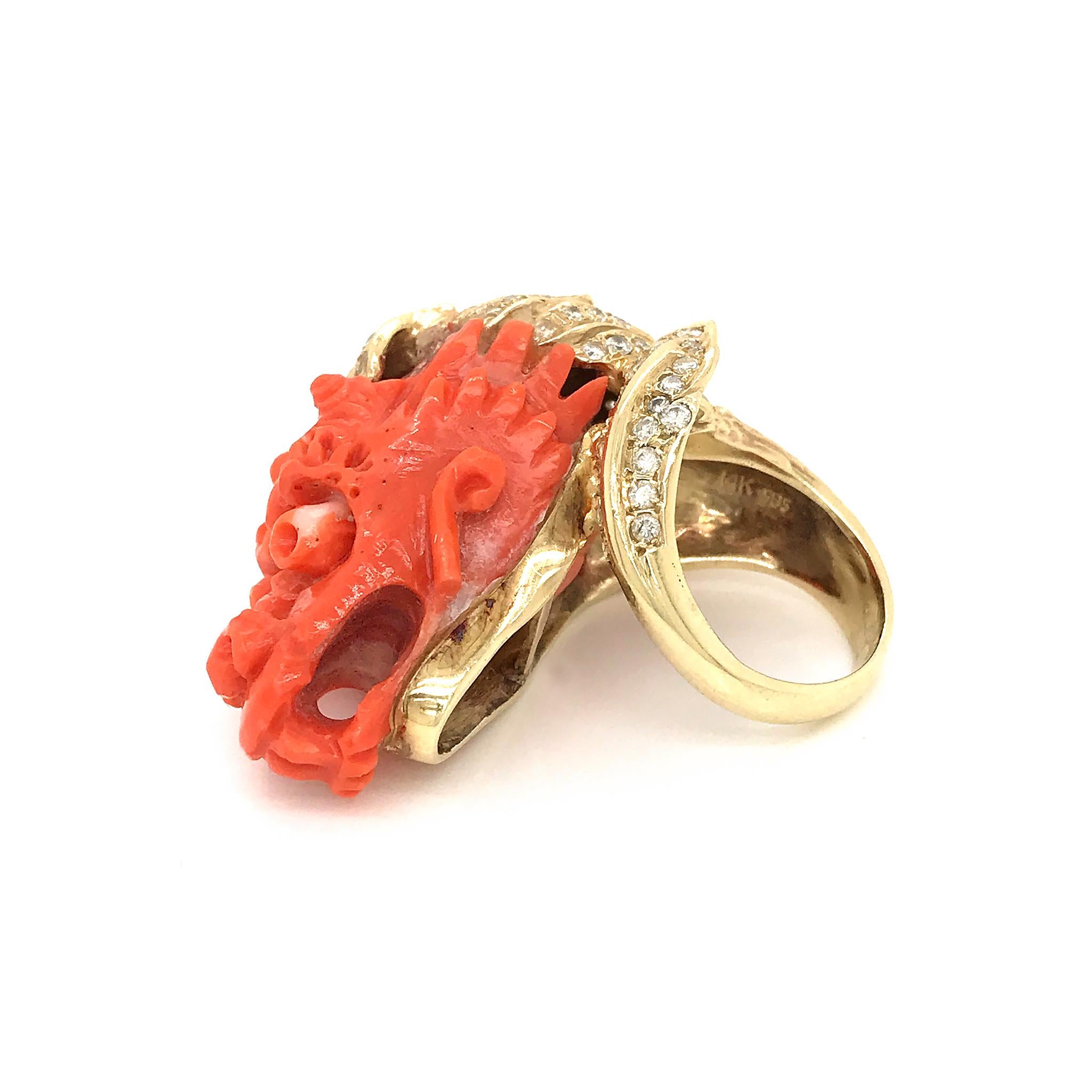 Estate 18K Yellow Gold Carved Coral and Diamond Dragon Head Ring.

Since dragons aren’t real, it seems a little silly to talk about what they are. But the creature who breathes fire and has wings and can fly is a really a more recent dragon. This