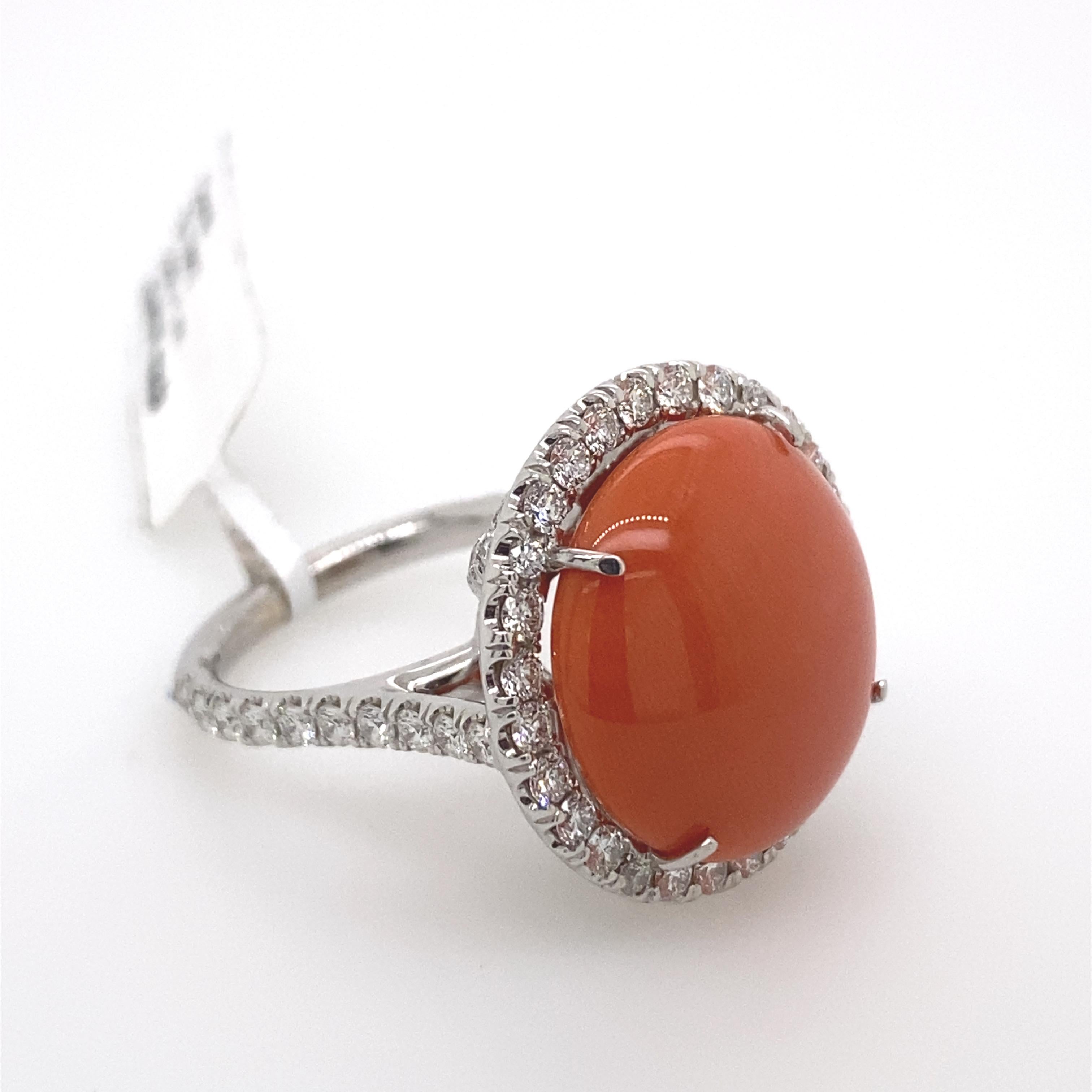 Exquisite coral and diamond ring. 
Pear cabochon coral surrounded by 1.61ct of round cut diamonds, set in 18-karat white gold.
Accommodated with an up to date appraisal by a GIA G.G., please contact us with any questions. Thank you. 

Item Number