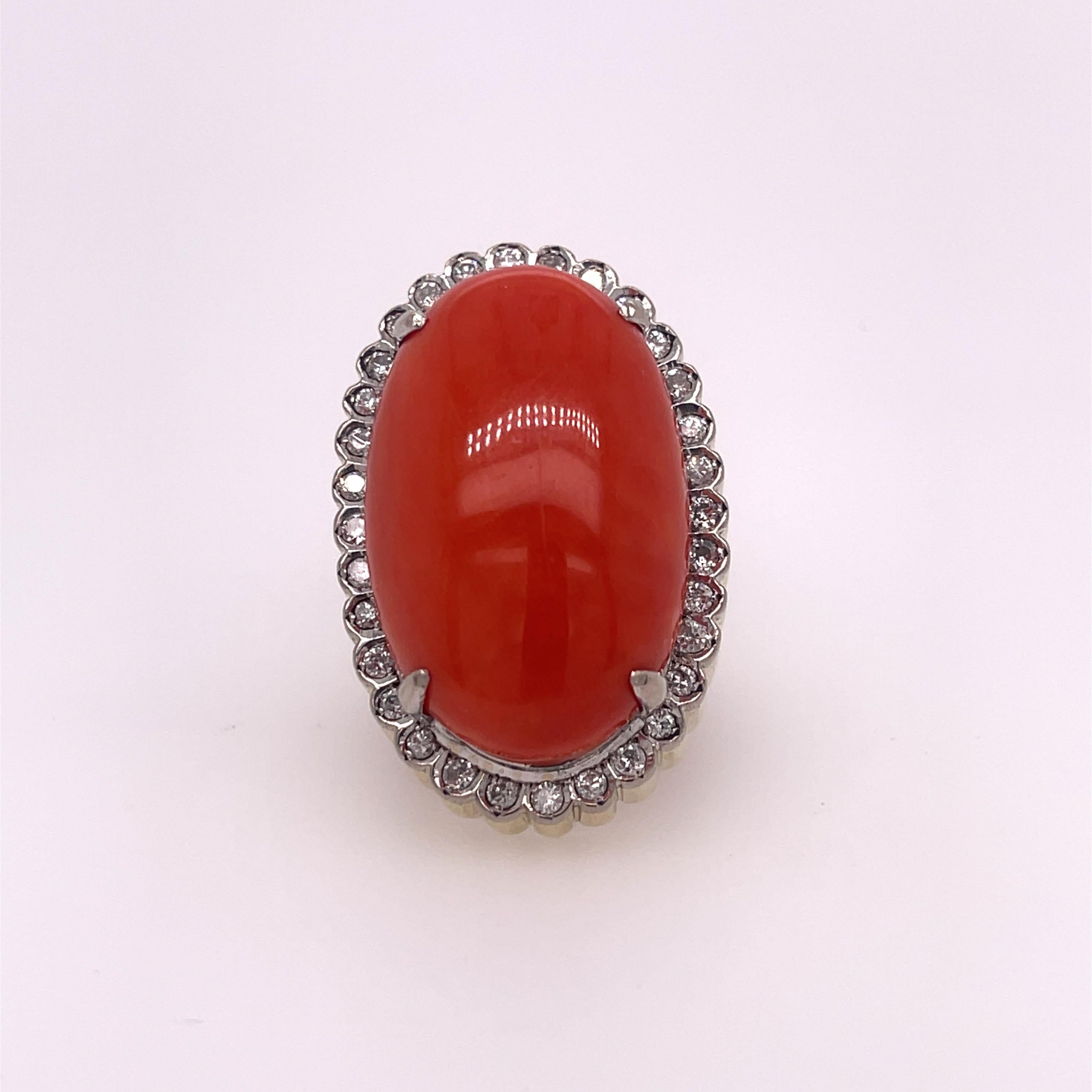 Oval coral ring with a diamond halo set in 14K yellow gold. The coral is approximately 26mm x 17mm.
Approximately 0.50ctw of diamonds.  Stamped 585 14k.