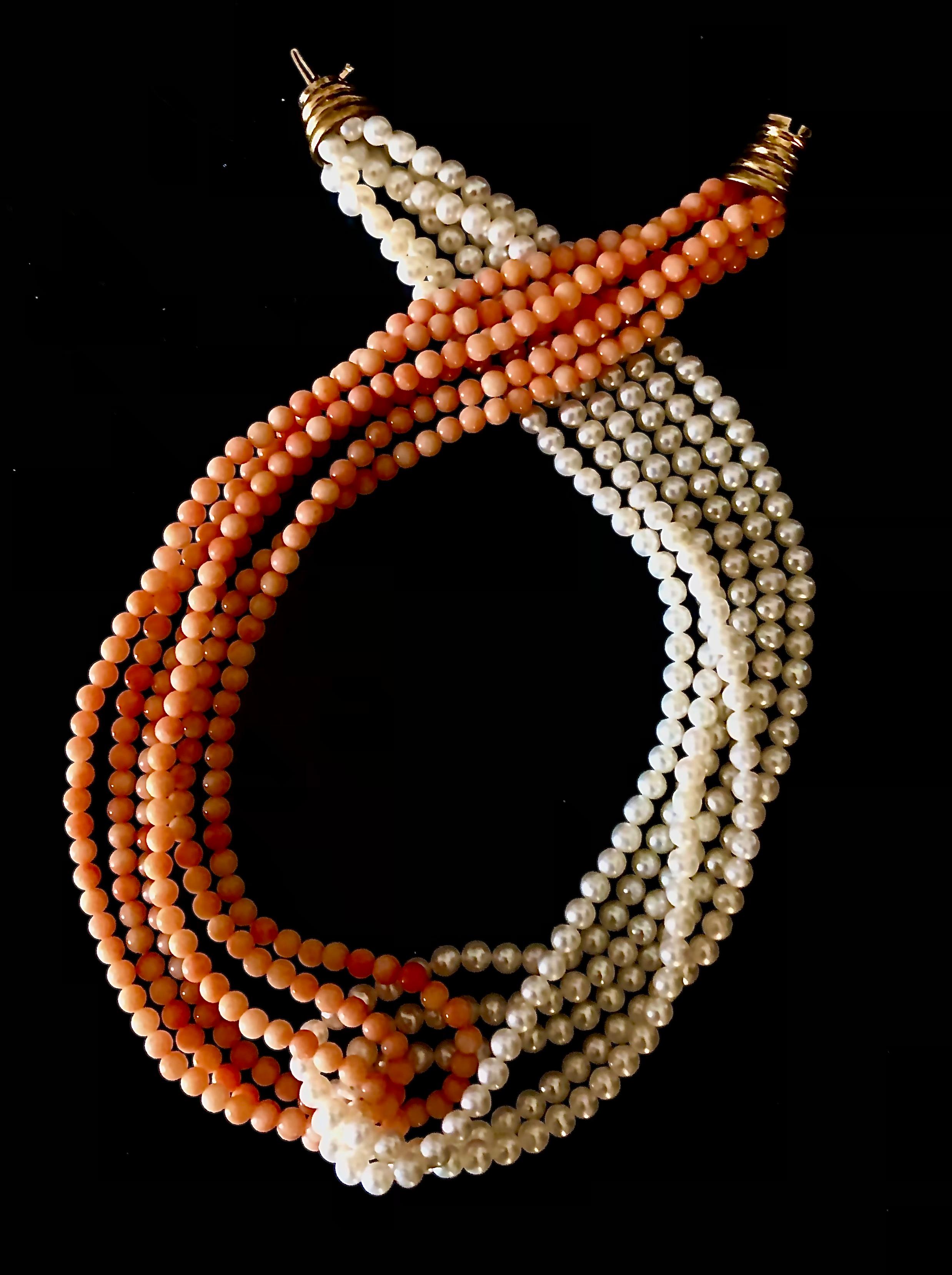 This is an interesting necklace comprised of twin six strands of peachy pink 4.1mm coral beads on one side and six strands of 4.3mm cultured pearls on the other which intersect in the middle. This combination produces a stunning effect.

The pearls