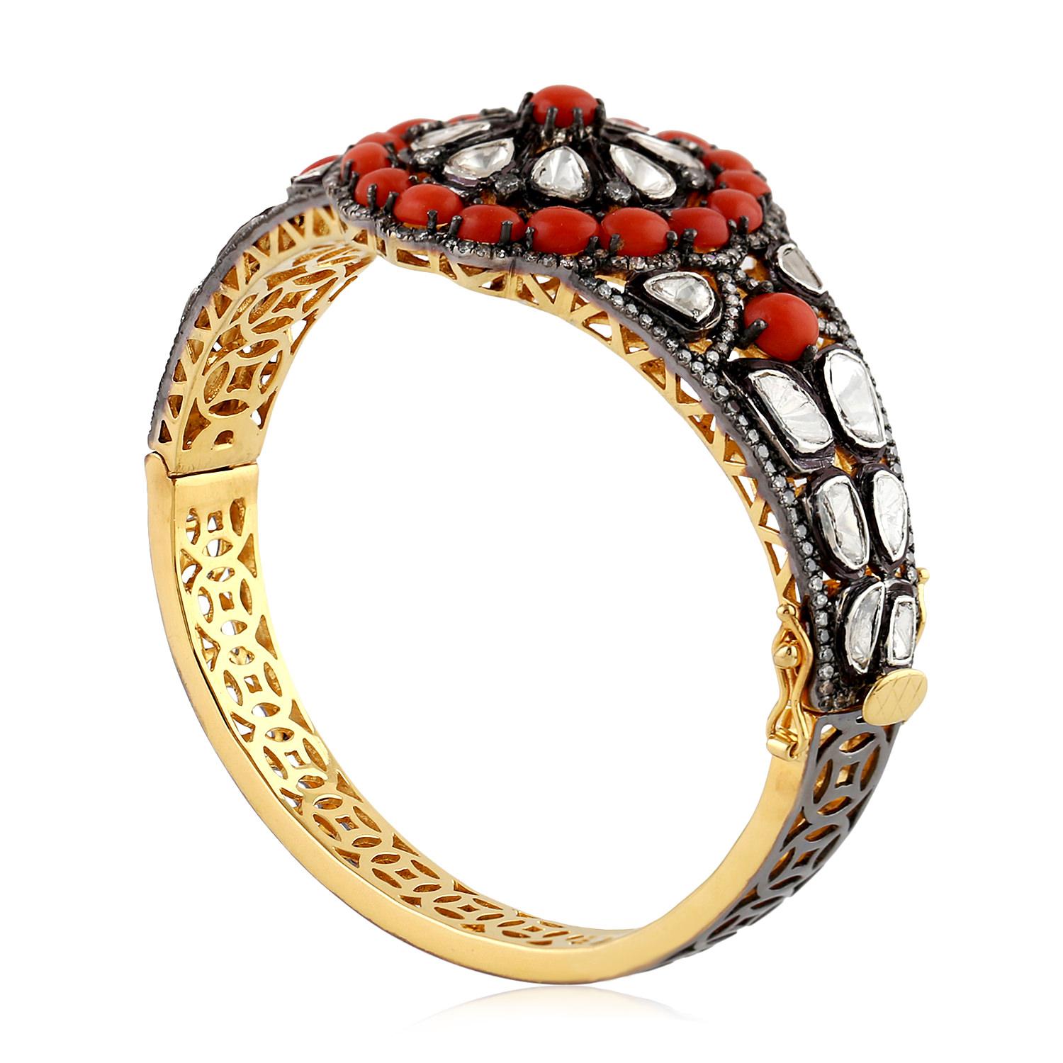 Pretty in coral, this floral designer bangle in rosecut diamond and coral is perfect for any occasion. As this bangle is openbale and oval in shape it sits on the wrist perfectly.

Closure: Box Clasp with safety clasp

18KT: 2.284gms
Diamond: