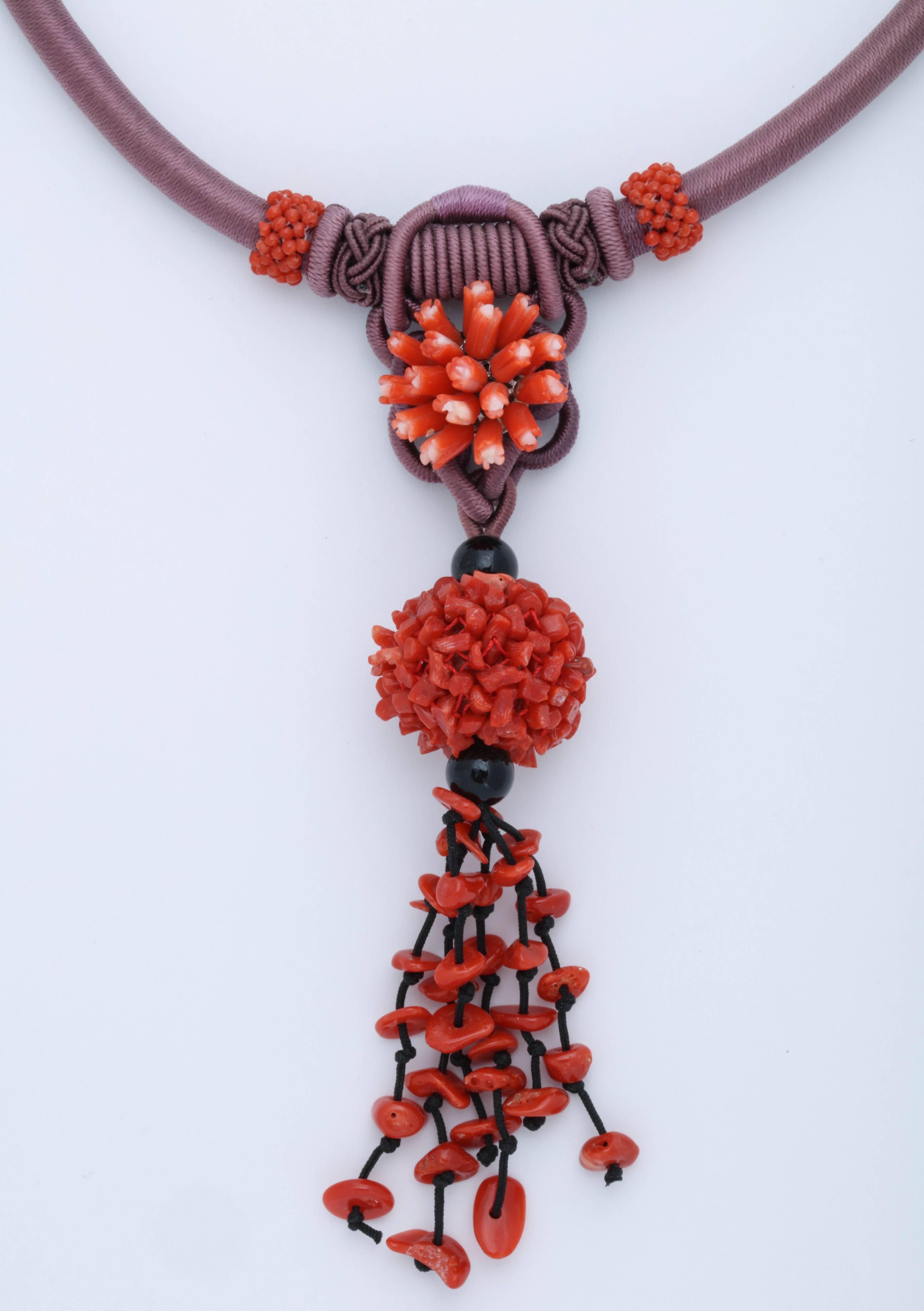 Unique combination of purple and bright red-orange natural coral beads. The length is 16 in and can be extended to 18 in. 
Excellent  and detailed work with twisted and  knotted thread.