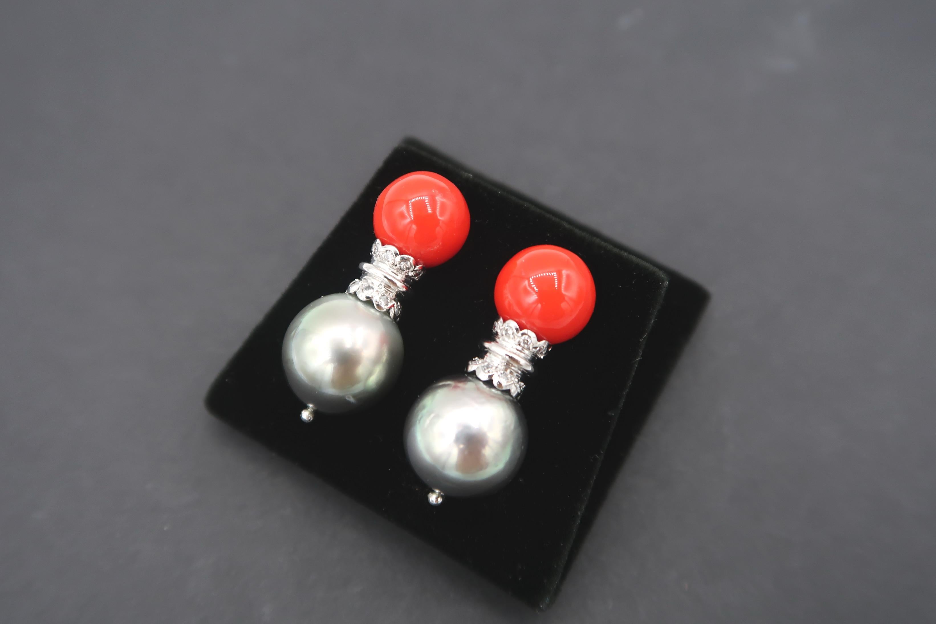 Coral and Tahitian Pearl Sconce Earrings embellished with Diamond in 18K White Gold Setting

Diamond: 0.40ct.
Gold: 18K White Gold 4.56g.
Tahitian Pearls: 12.5mm
Coral