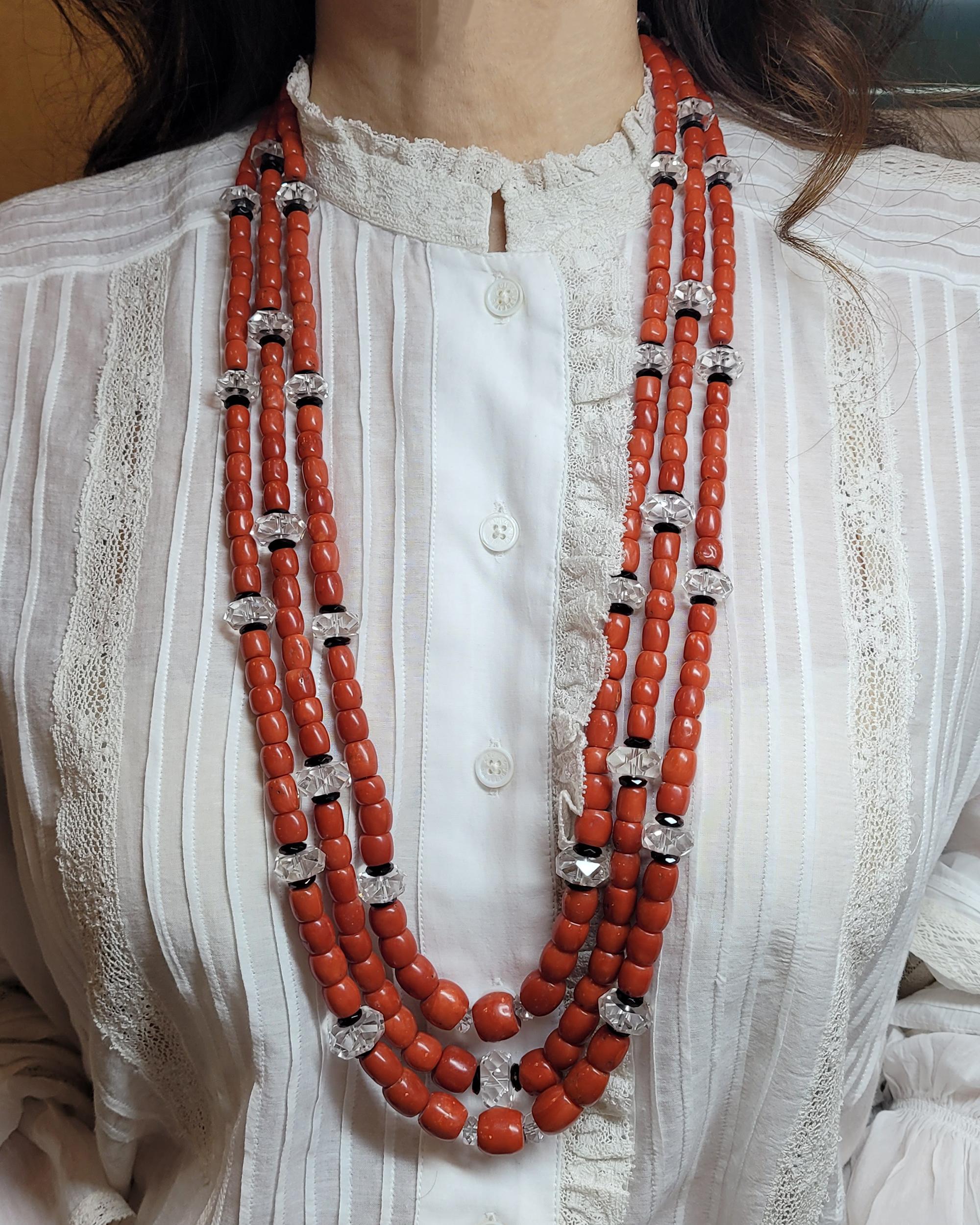 A colorful three-strand necklace can complete a fashionable sundress as elegantly as it can add a solid impact to a smartly tailored suit. This ultra-long and versatile Coral Bead Rock Crystal Necklace, made in the 21st Century, will take you from
