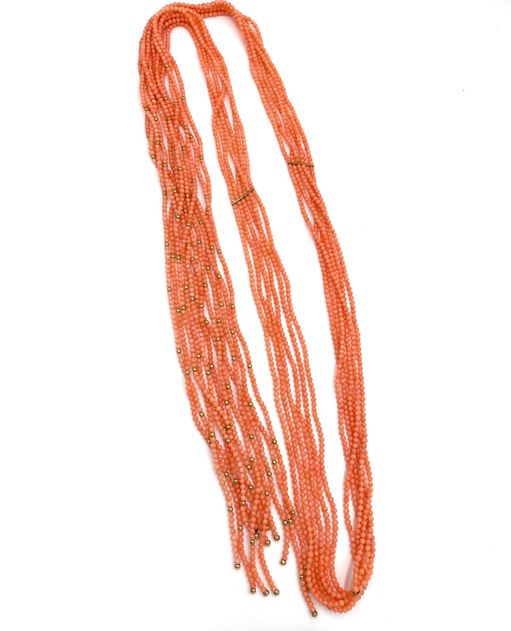 Pre owned vintage estate multi strand coral beaded scarf necklace with 18k yellow gold beads.  The unique strand is 58 inches long and they are strung with three keepers/bars: One in the center back and two 9.75  inches down on either side.  There