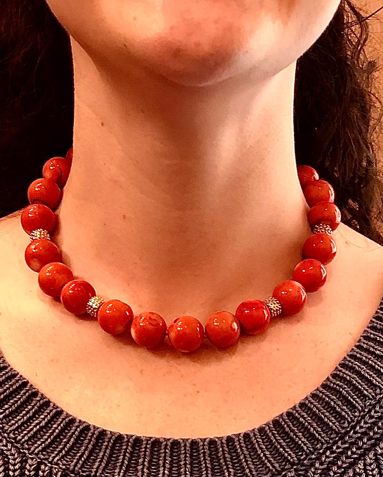 Choker necklace of extraordinarily sized round Momo coral beads with custom made 14kt. gold granulated textured clasp and large rondelles.

Very beautiful and vibrant coral color with subtle white dots and shading inherent in this variety of natural