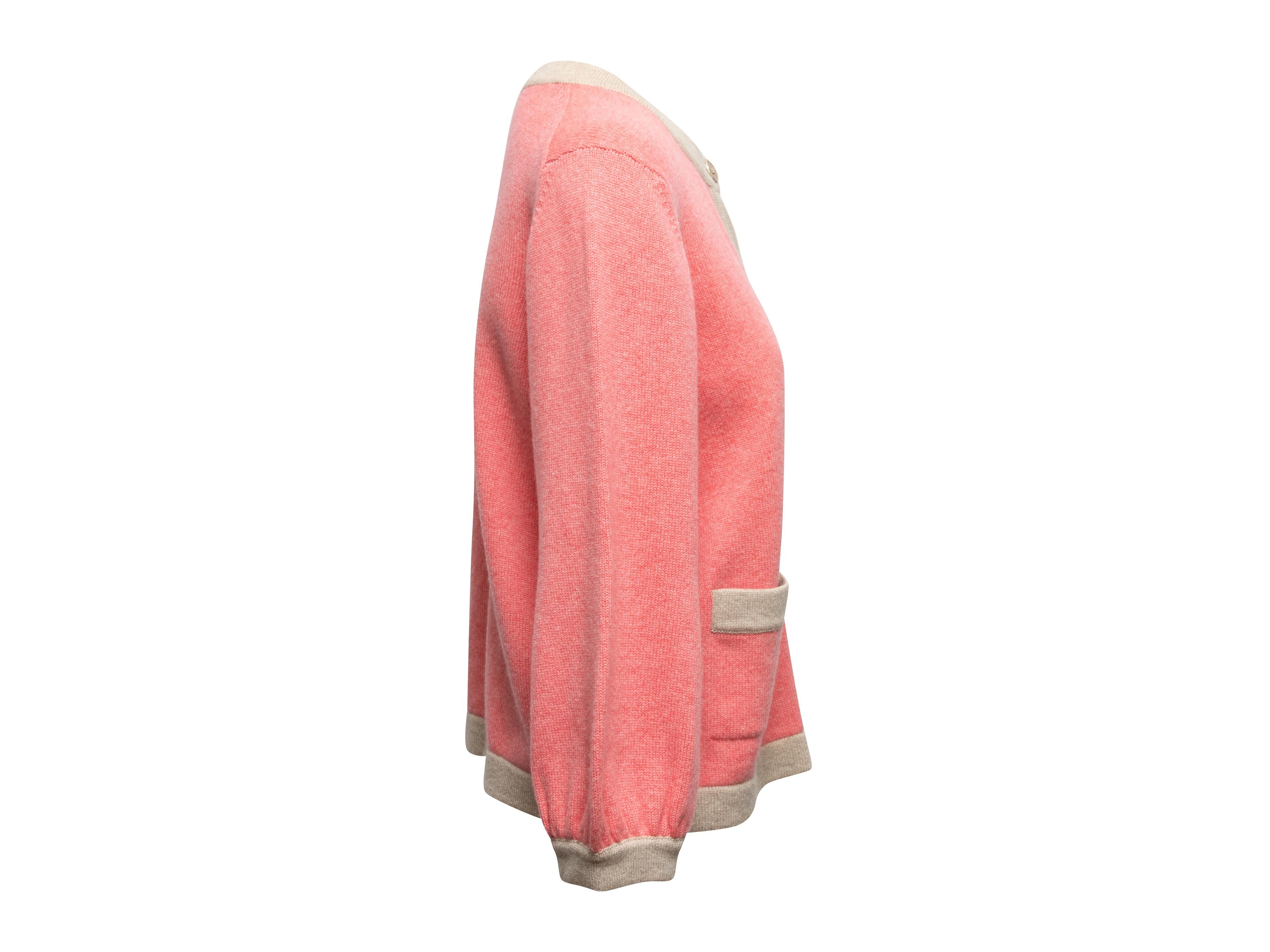 Coral and beige cashmere cardigan by Chanel. From the Spring/Summer 2008 Collection. Crew neck. Dual pockets. Button closures at center front. 41