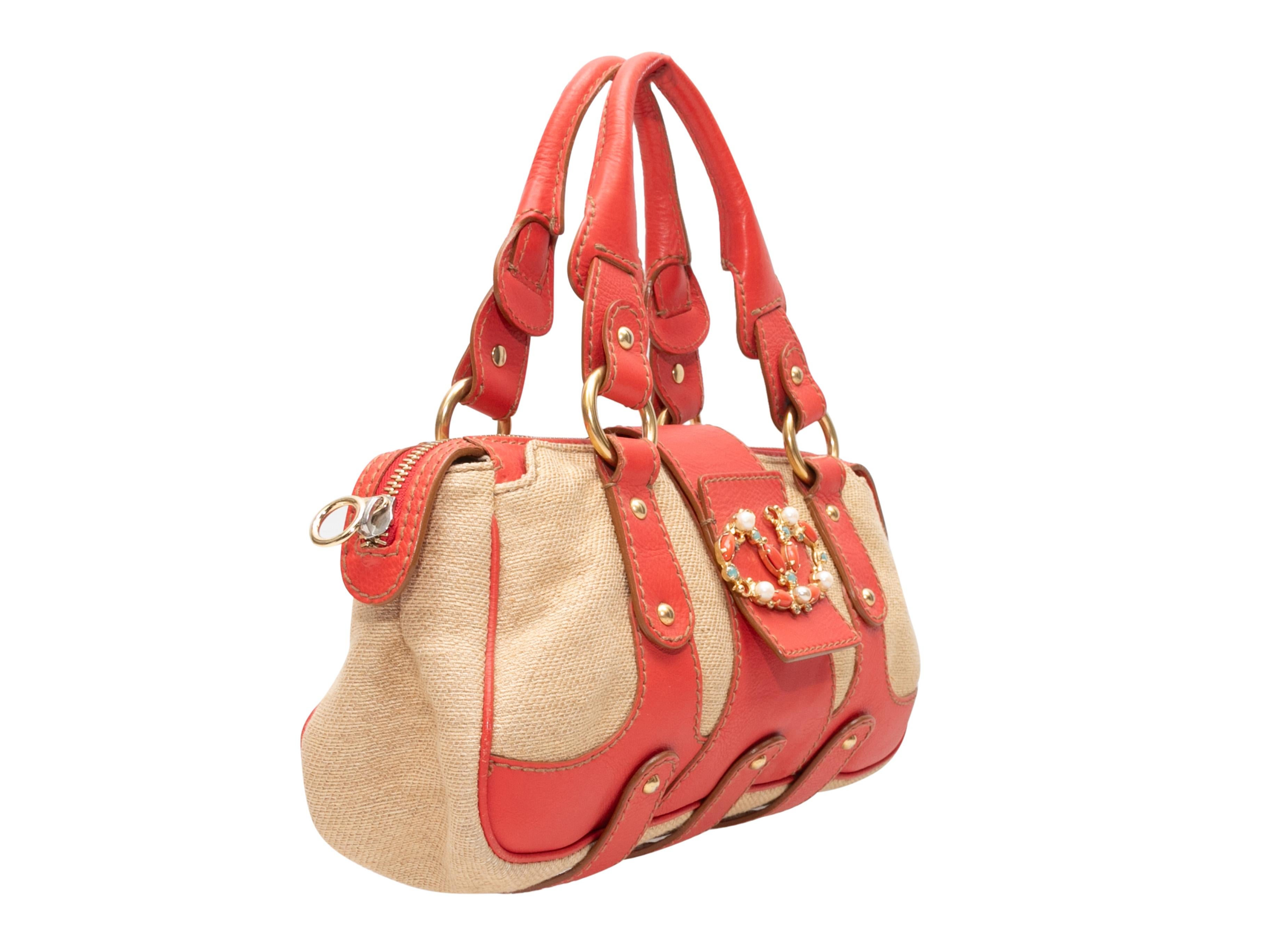 Coral & Beige Valentino Top Handle Tote. This tote bag features a leather and canvas body, gold-tone hardware, an enameled front logo embellishment, dual rolled top handles, and a top zip closure. 13.25