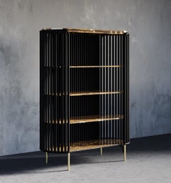 Libreria Coral in pietra occhio di tigre con intarsi in ottone