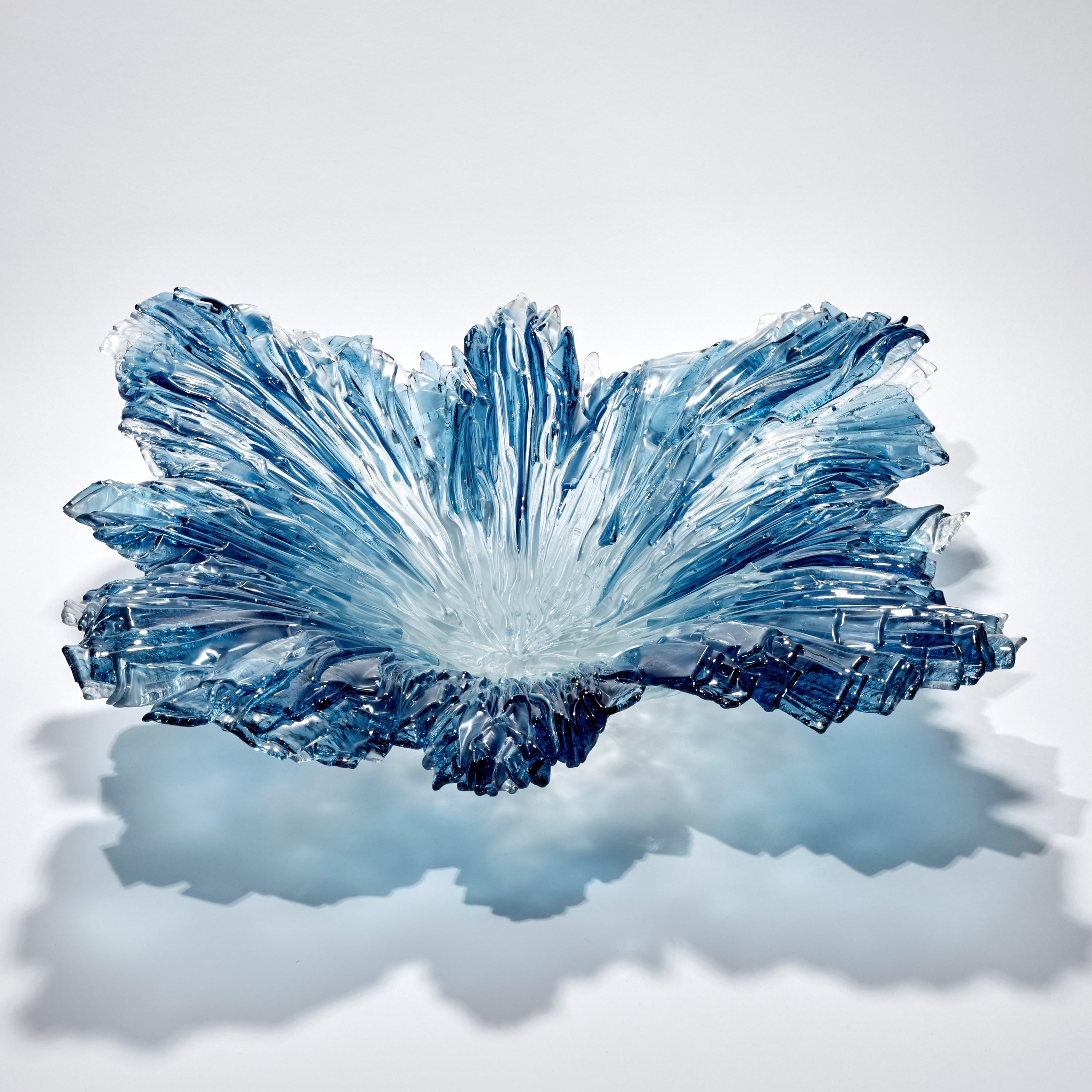 'Coral Bowl in Aqua' is a unique glass sculptural centrepiece by the British artist Wayne Charmer. 

For Wayne Charmer, the fascination of glass is to exploit its translucent and reflective qualities. Inspired by nature, his signature techniques