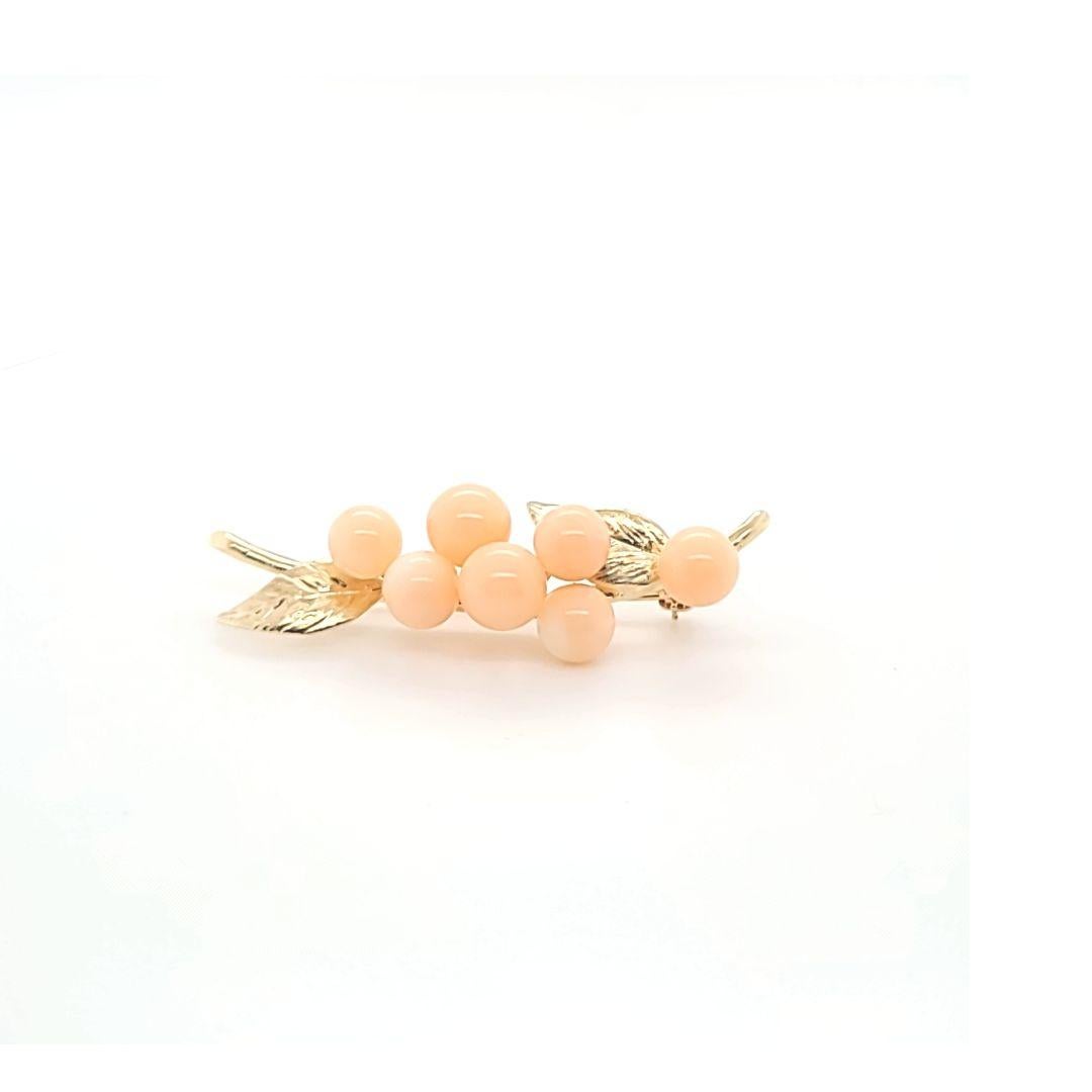 14 Karat Gelbgold Branch Pin mit 7 runden Engel Haut Korallen und strukturierte Blatt Detail. 1,75 Zentimeter lang. Das fertige Gewicht beträgt 4,7 Gramm.