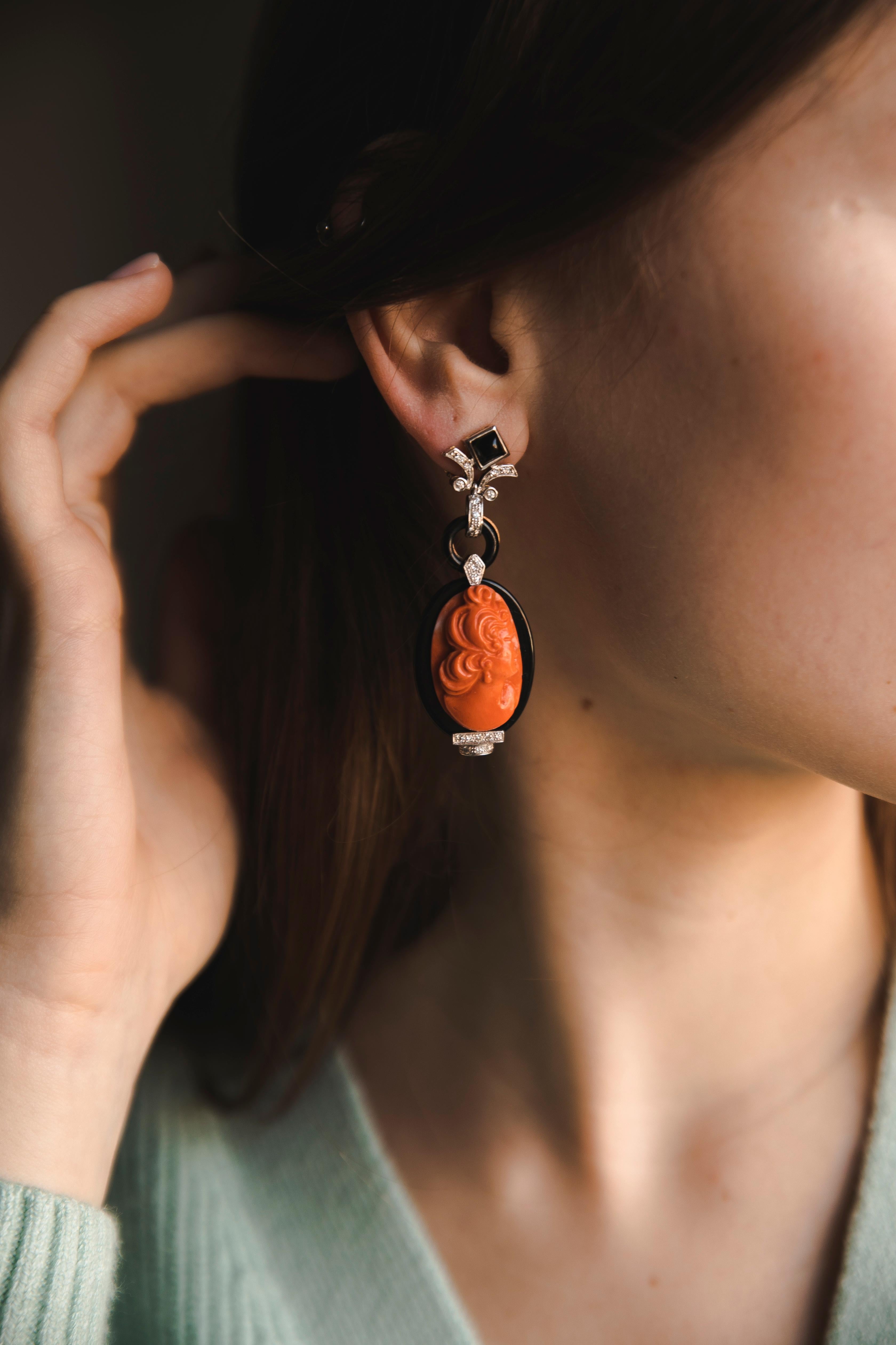 Coral Cameo Onyx Diamonds White Gold Earrings. Cameos on Coral of ladies profile resembles the Greek style but in a modern way. A fine black Onyx framing and Onyx chain link make the cameos move freely and sit perfectly on the ear. Fine work of a