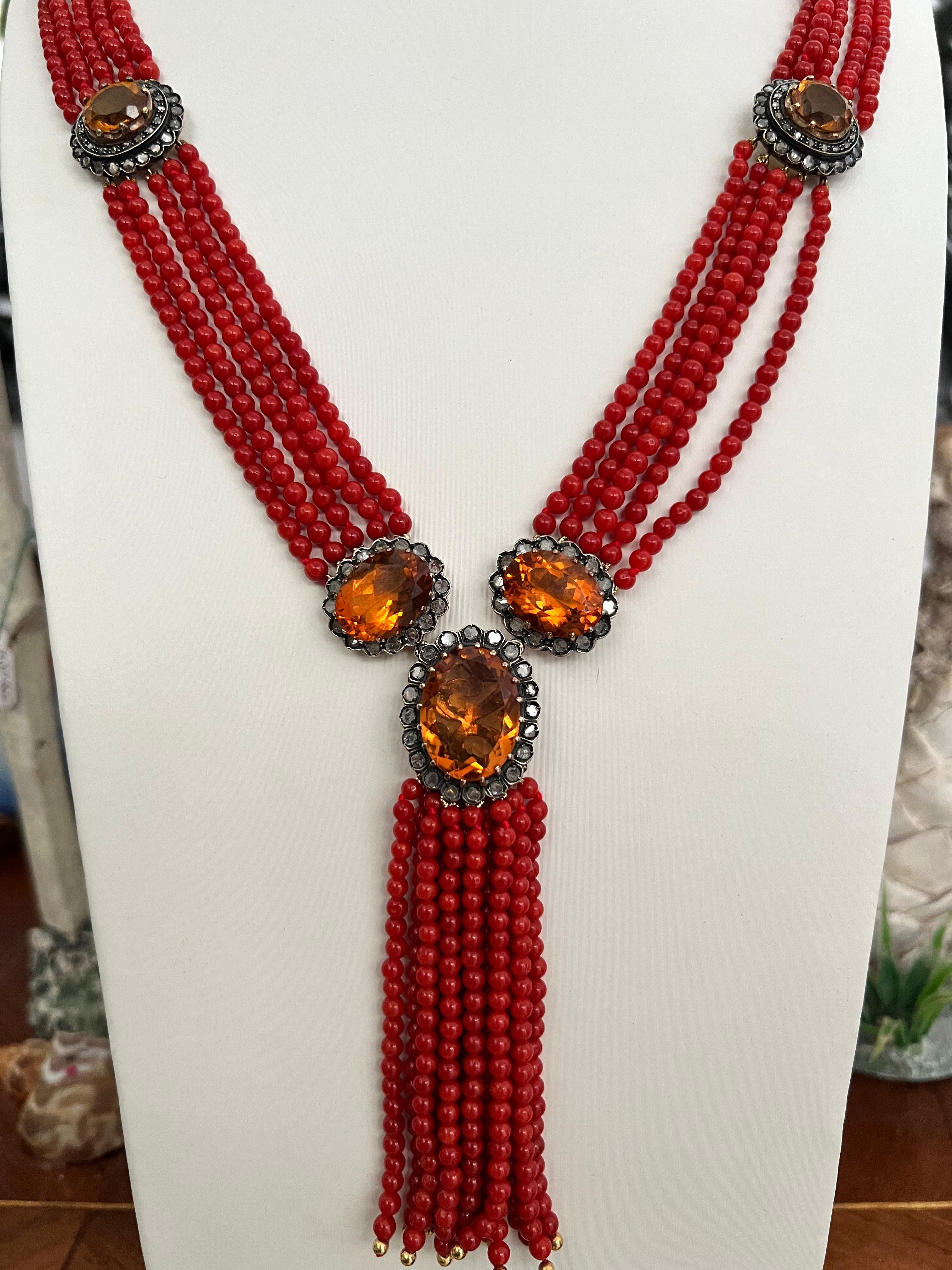 Beautiful natural coral necklace with 10 strands of coral and 5 citrines surronded with old cut diamonds.
The necklace is made in gold 14 karat and 800 thousandths silver.

Necklace total weight 97.20 grams
Diamonds weight 0.98 karat
Coral weight