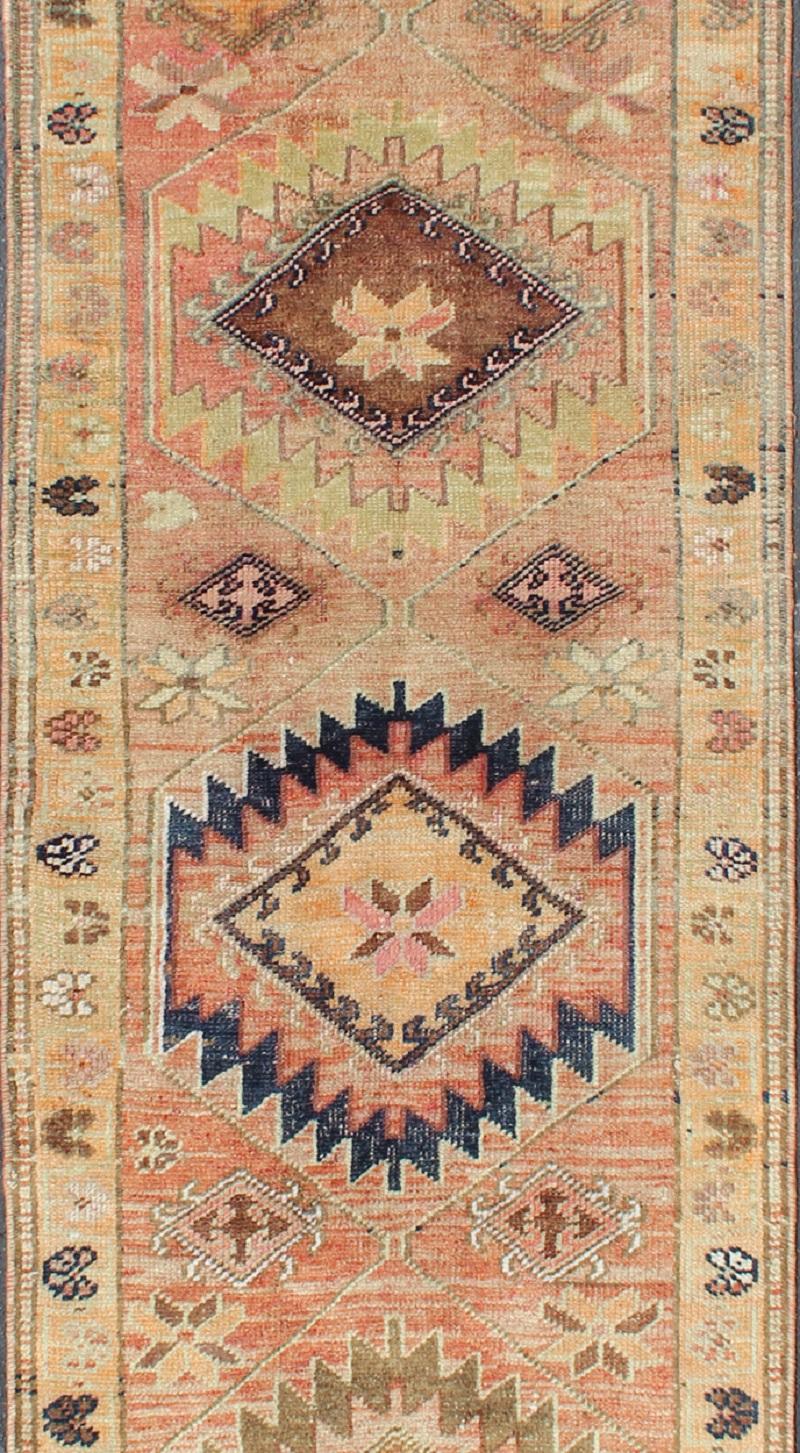Turkish Coral colored Vintage Oushak Runner with Geometric Medallions For Sale