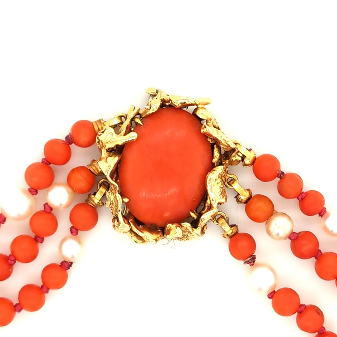 A beautiful necklace made of natural coral and cultured pearls. 
Created by David Webb. 
Featuring three strands of graduated coral and cultured pearls, with an 18k yellow gold and coral clasp.
Style no. 50631N
Serial no. KA56
Weight of the necklace